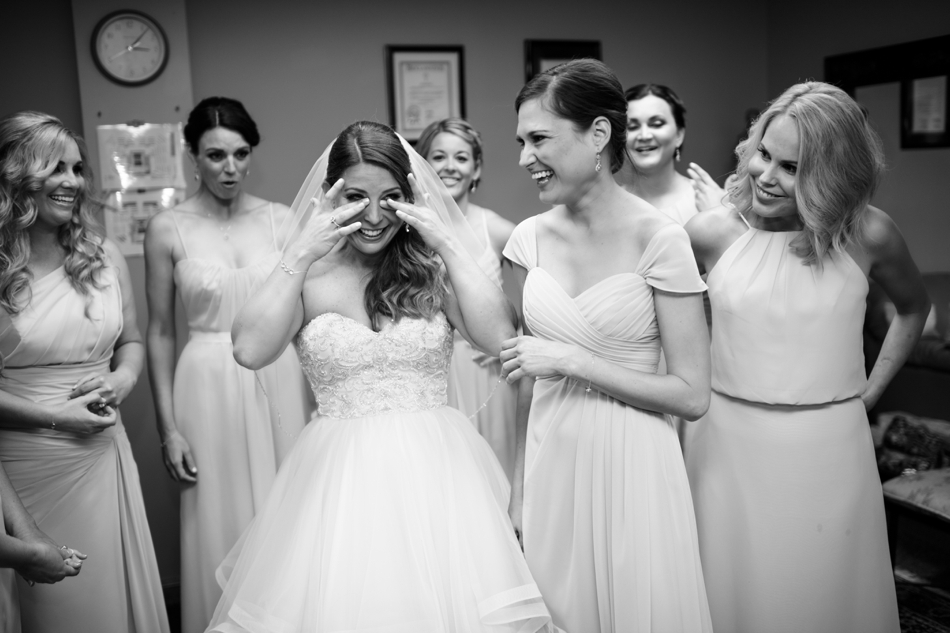Bride crying with bridesmaids 