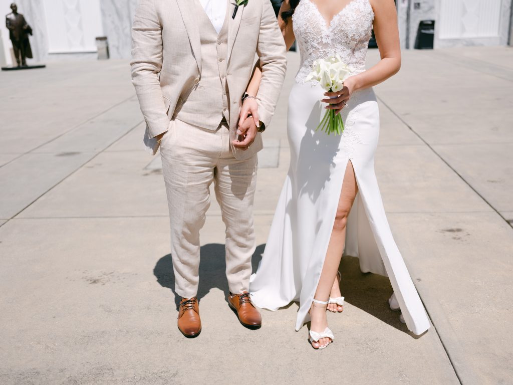 tan groom tux and lace wedding dress