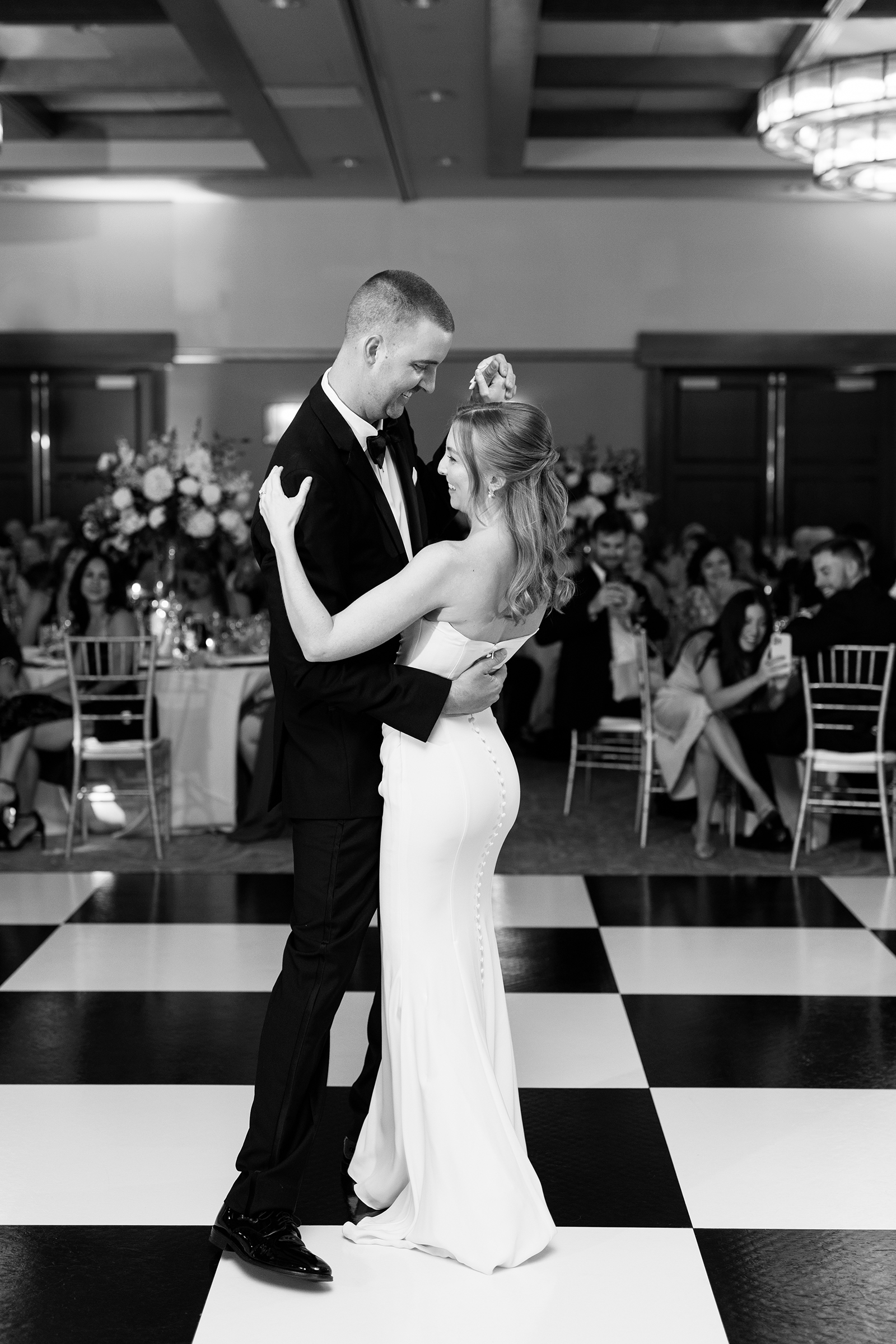 black and white portrait of bride and groom during their first dance