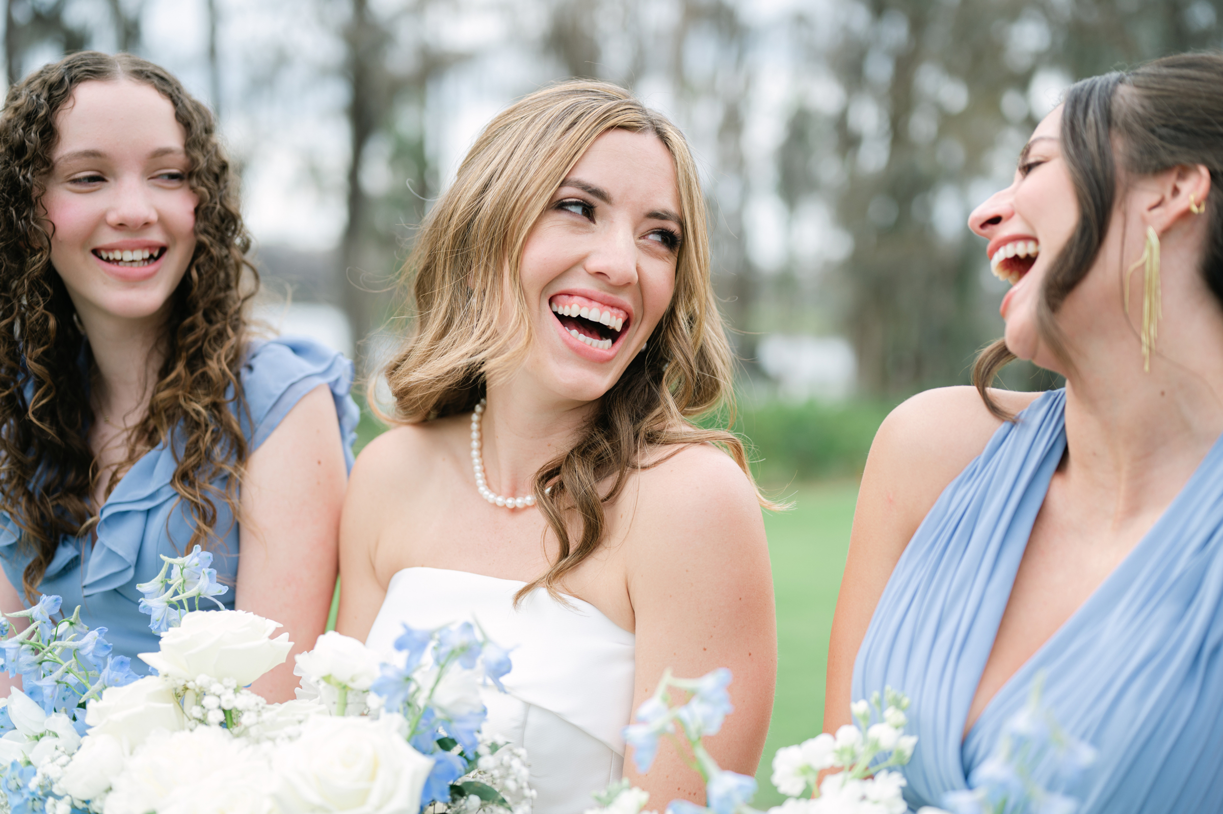 blue and white bridesmaid dresses with bouquets