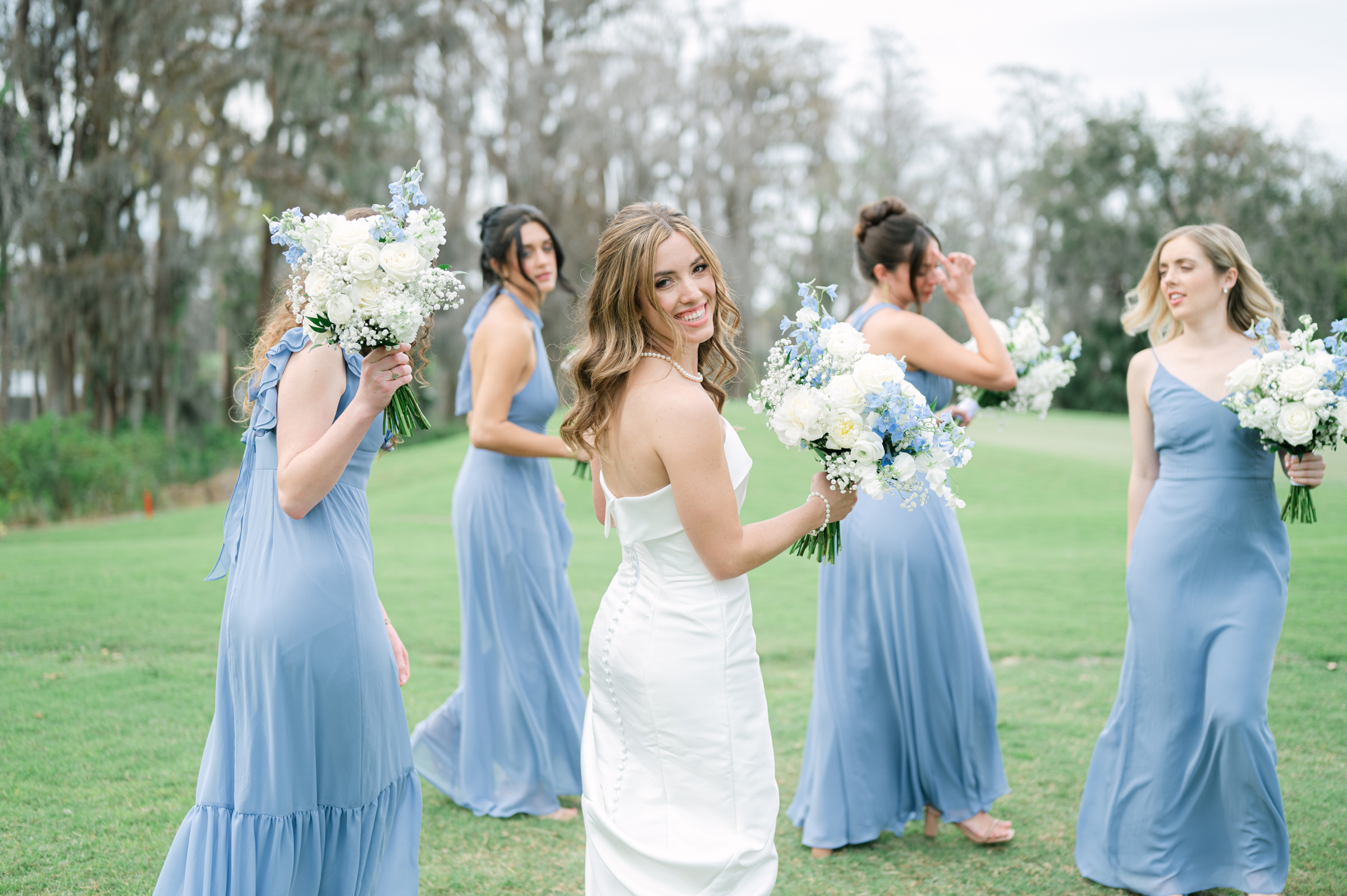 blue and white bridesmaid dresses with bouquets