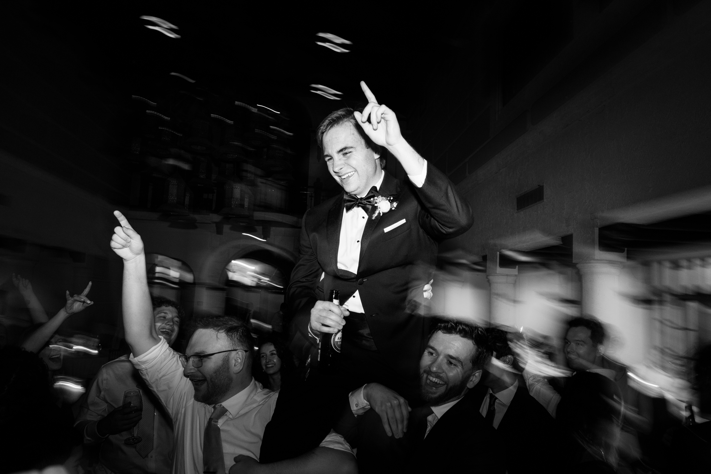 black and white picture of groom during reception
