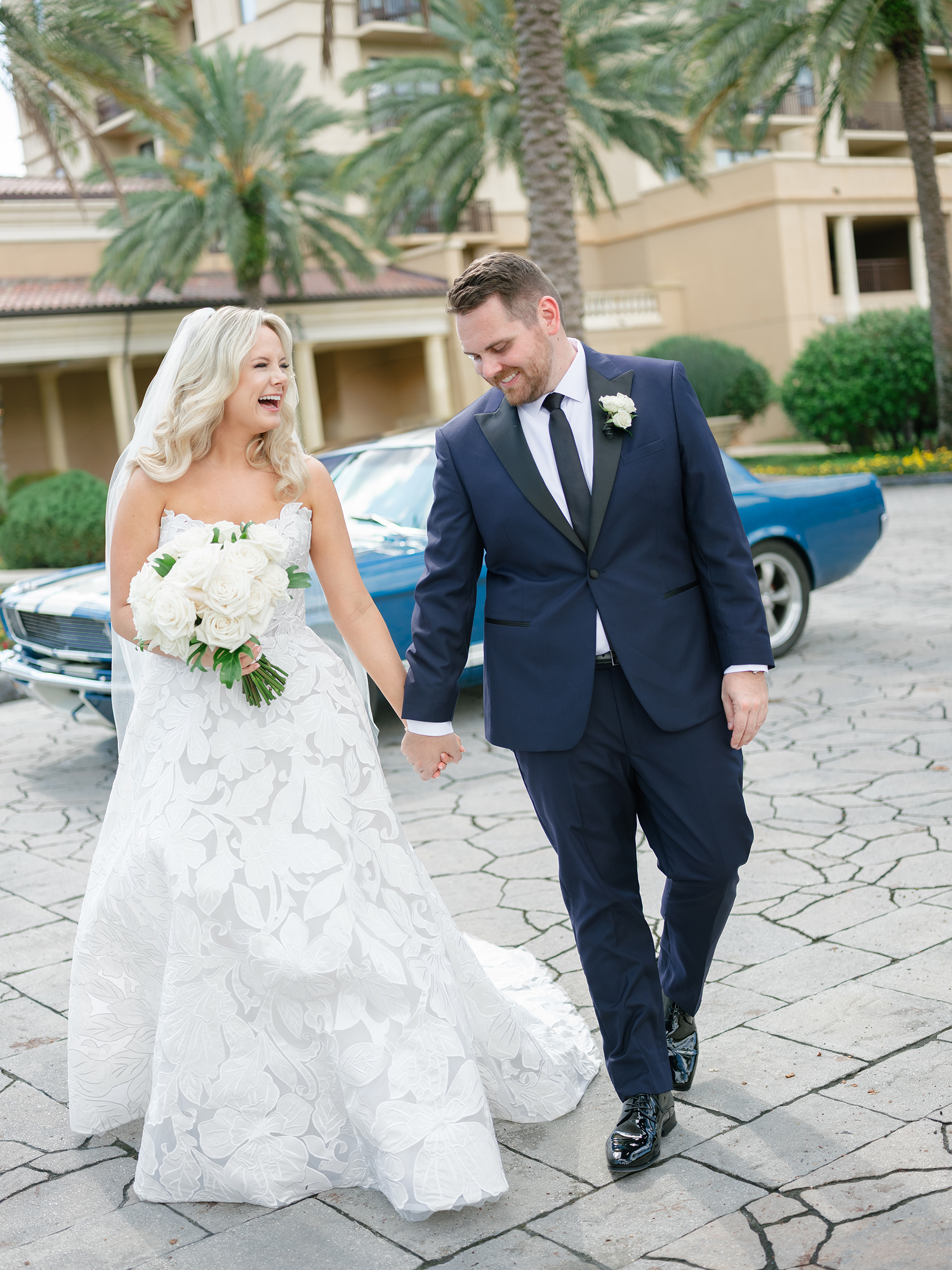 bride and groom traditional wedding picture in front of vintage car