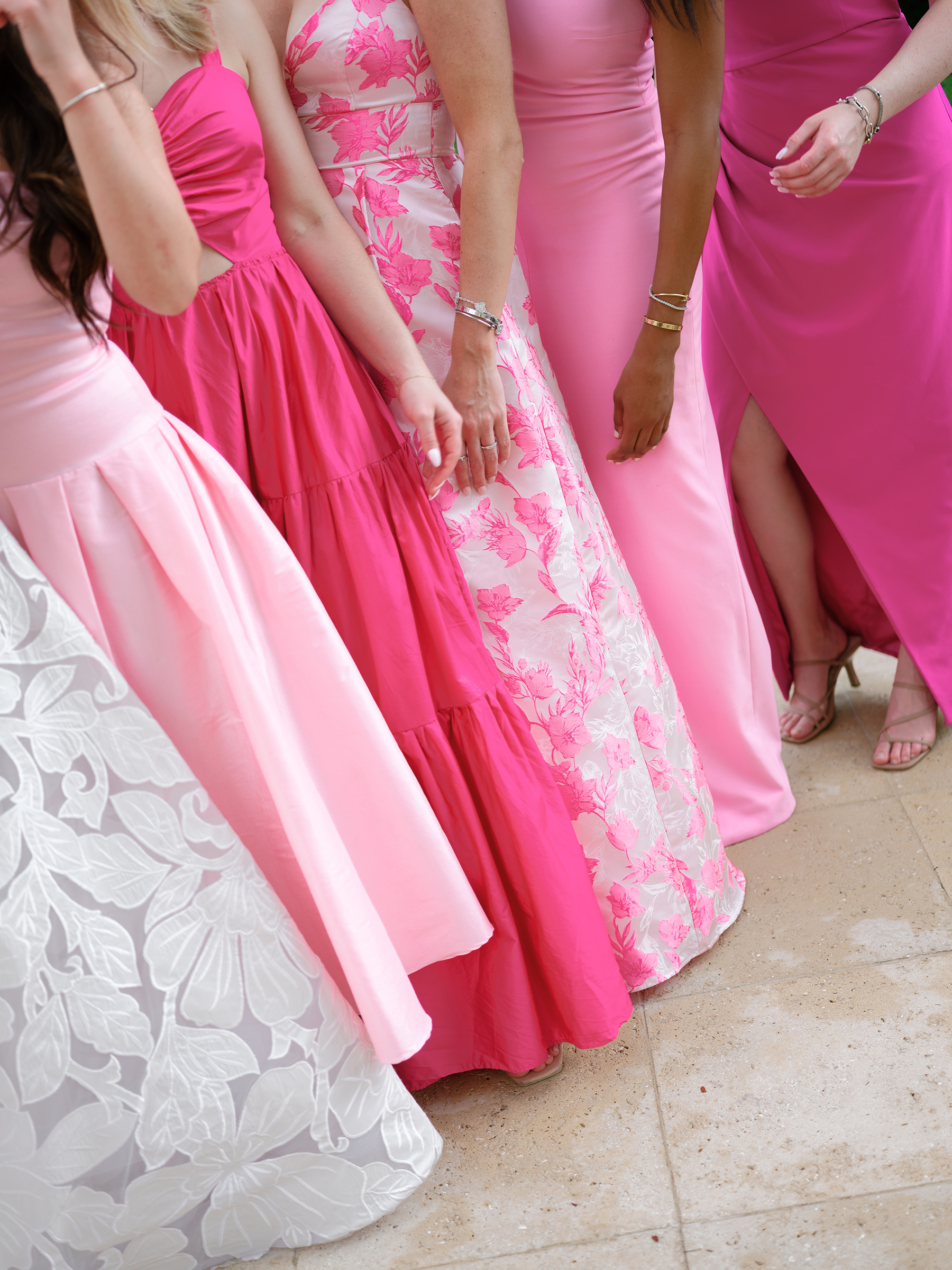 bride with bridesmaids in pink patterned colored dresses