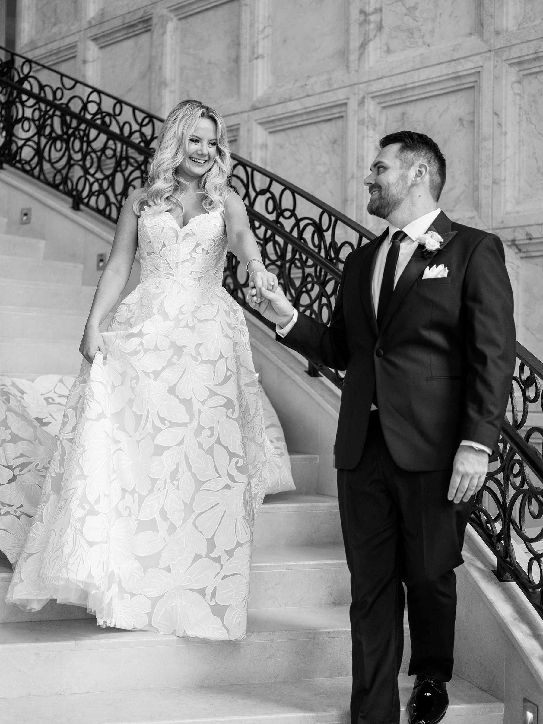 black and white picture of bride and groom on staircase
