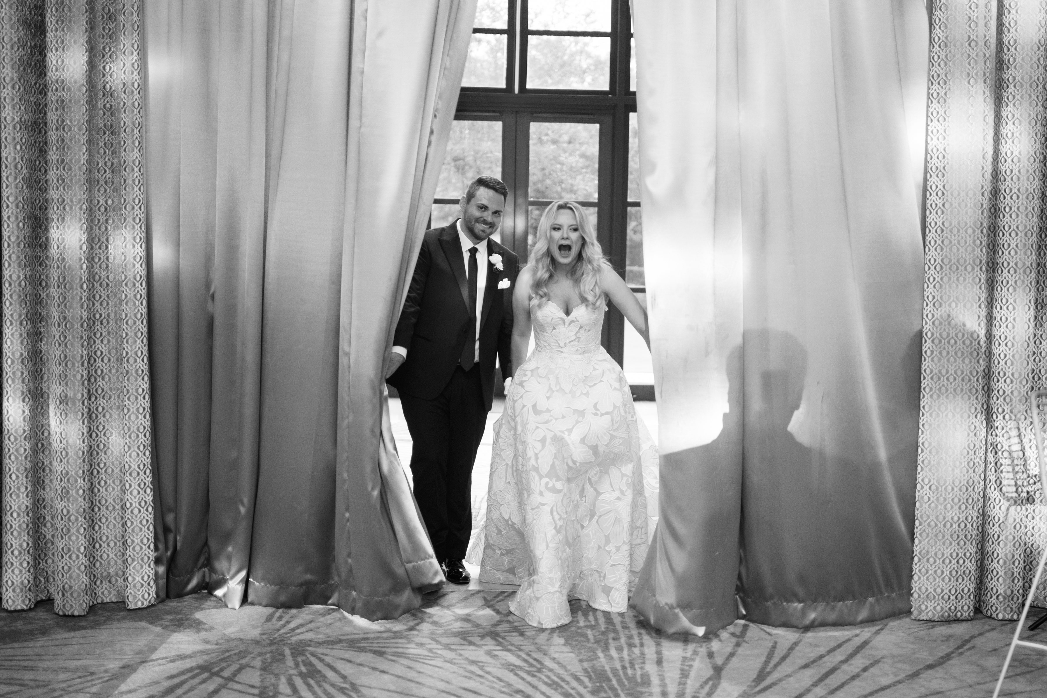 black and white picture of bride and groom's first look at reception