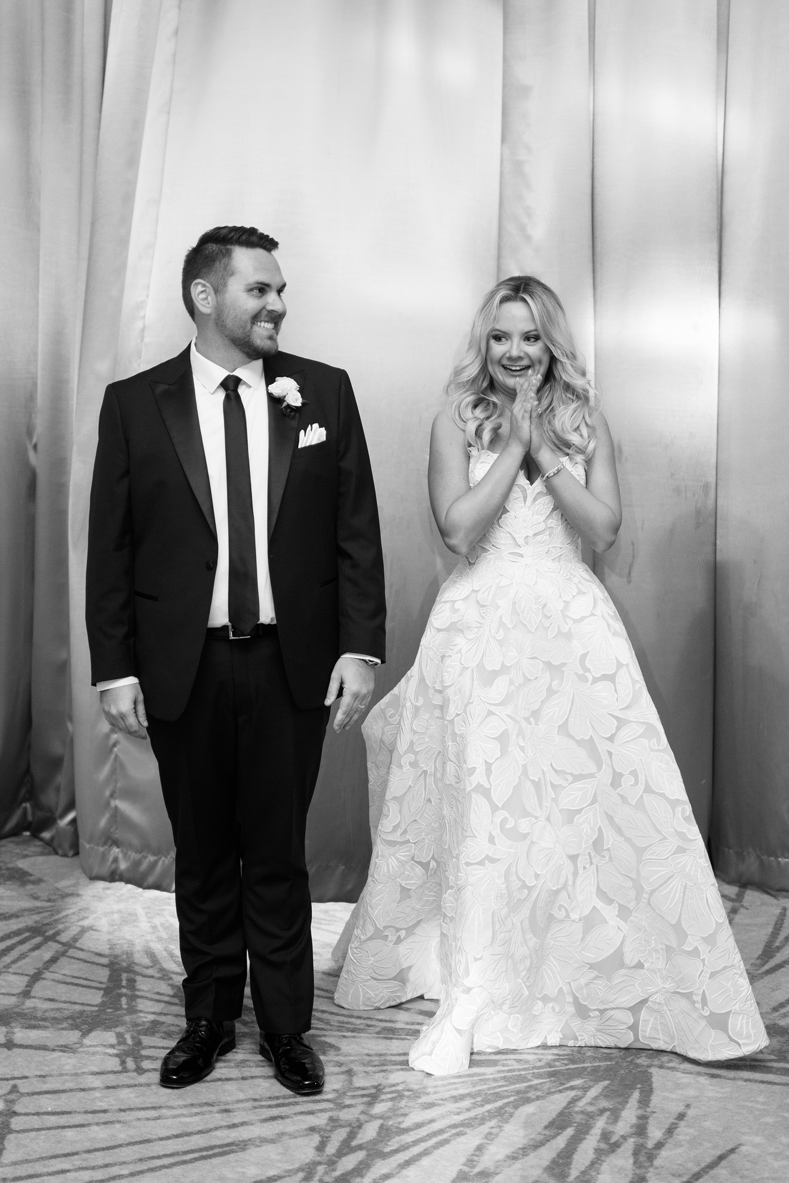 black and white picture of bride and groom's first look at reception