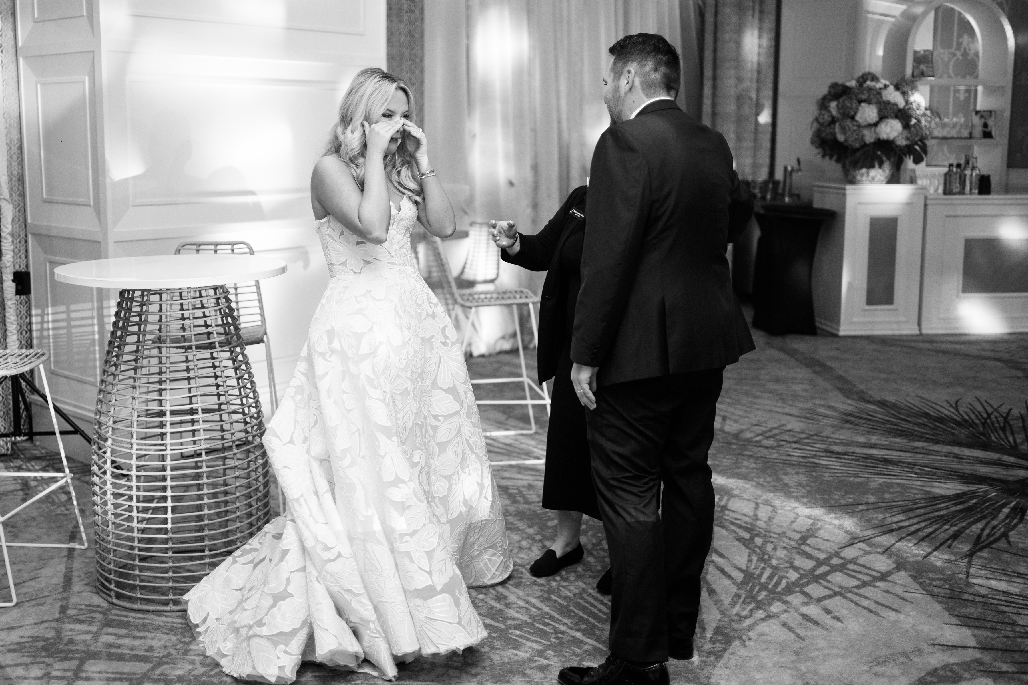black and white picture of bride and groom's first look at reception