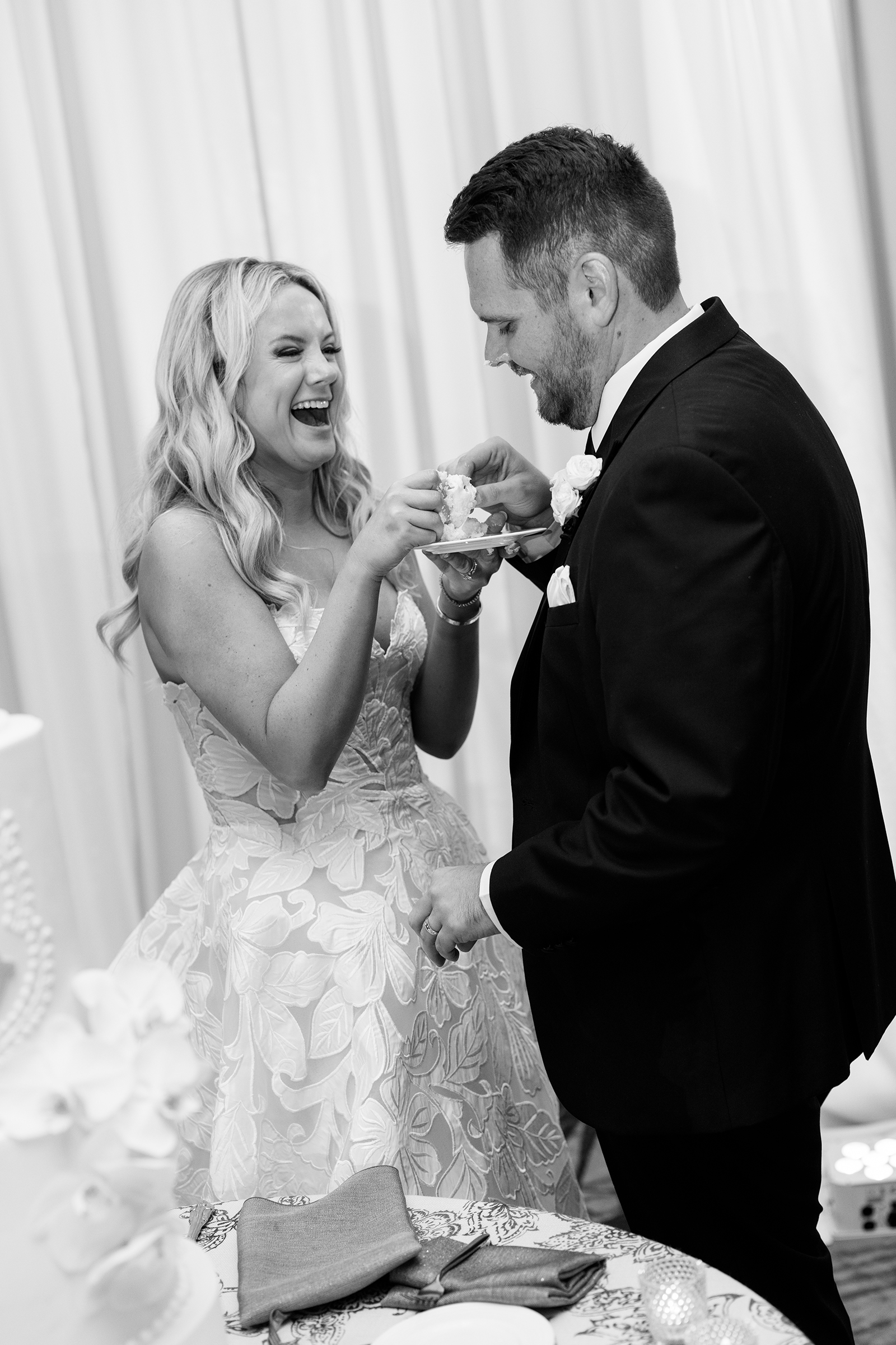 black and white picture during wedding cake tasting