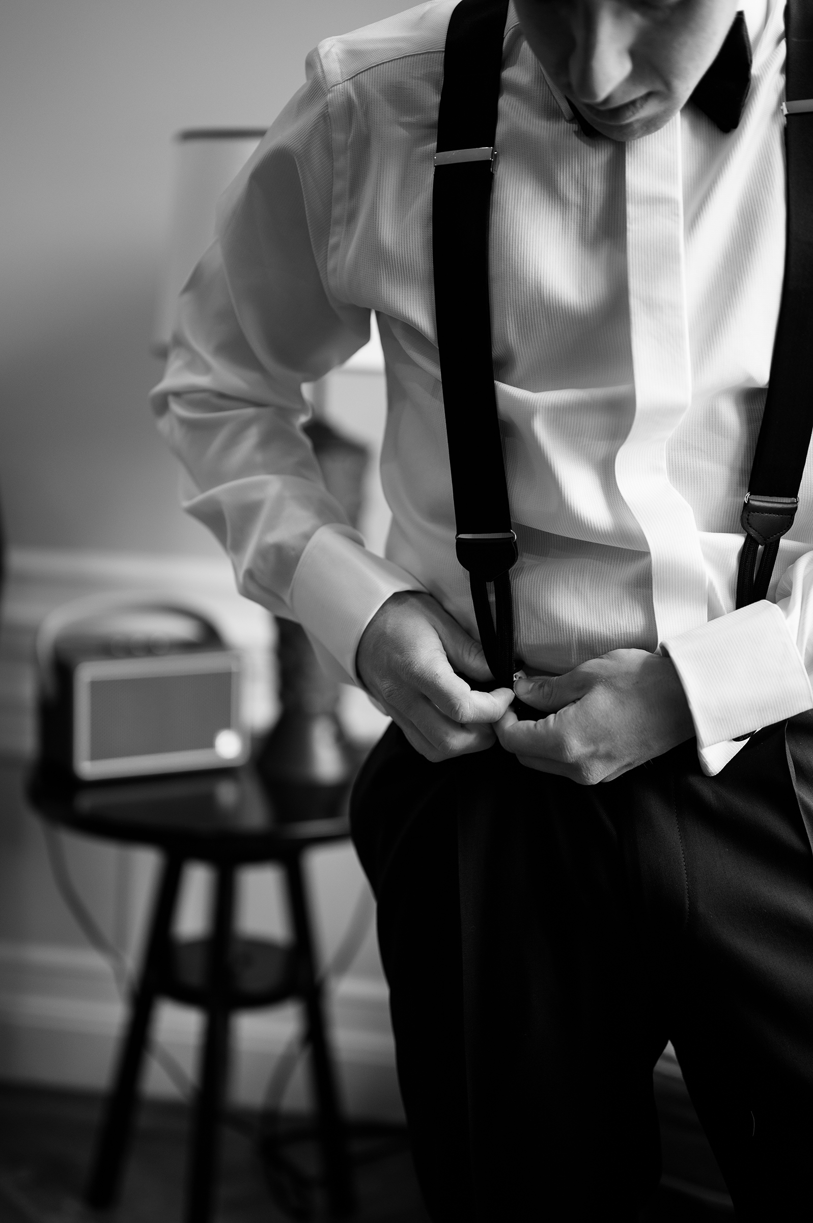 black-and-white picture of groom getting ready