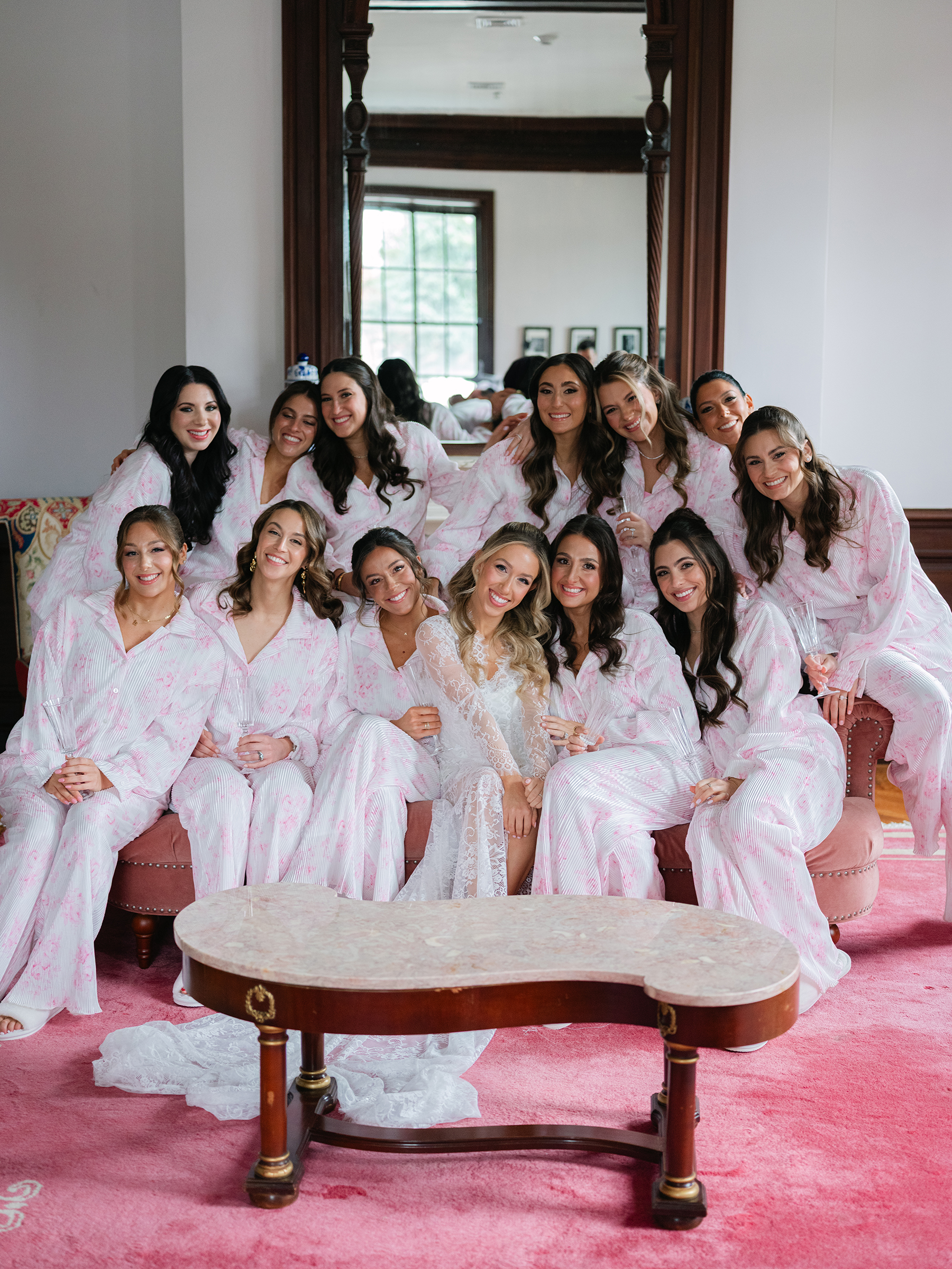 bride and bridesmaids in matching pink and white pajamas