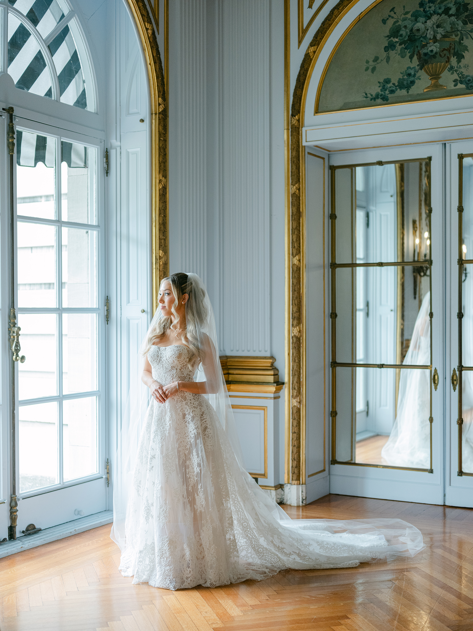 portrait of bride in corset top dress with long train