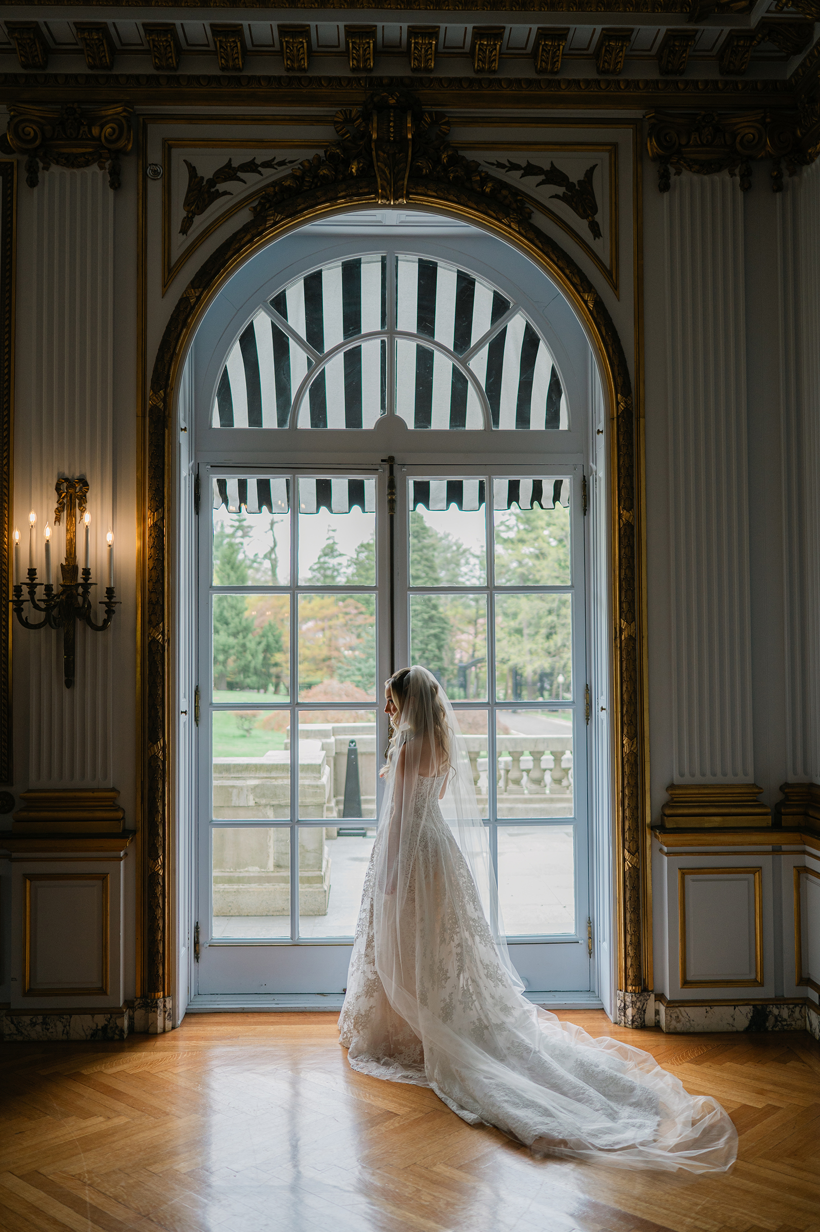 portrait of bride looking out of window