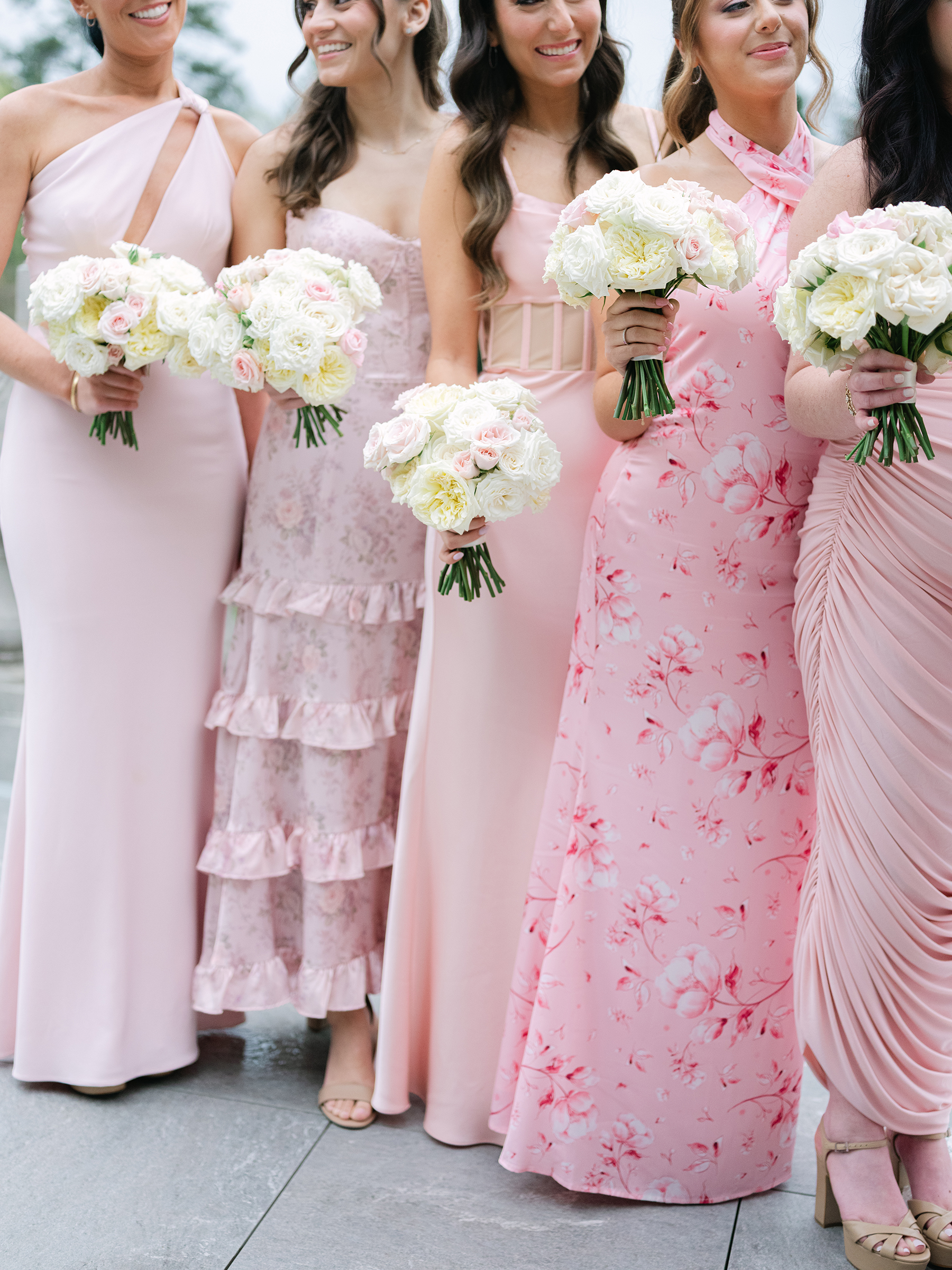 blush and baby pink bridesmaid dresses holding pink and white bouquets
