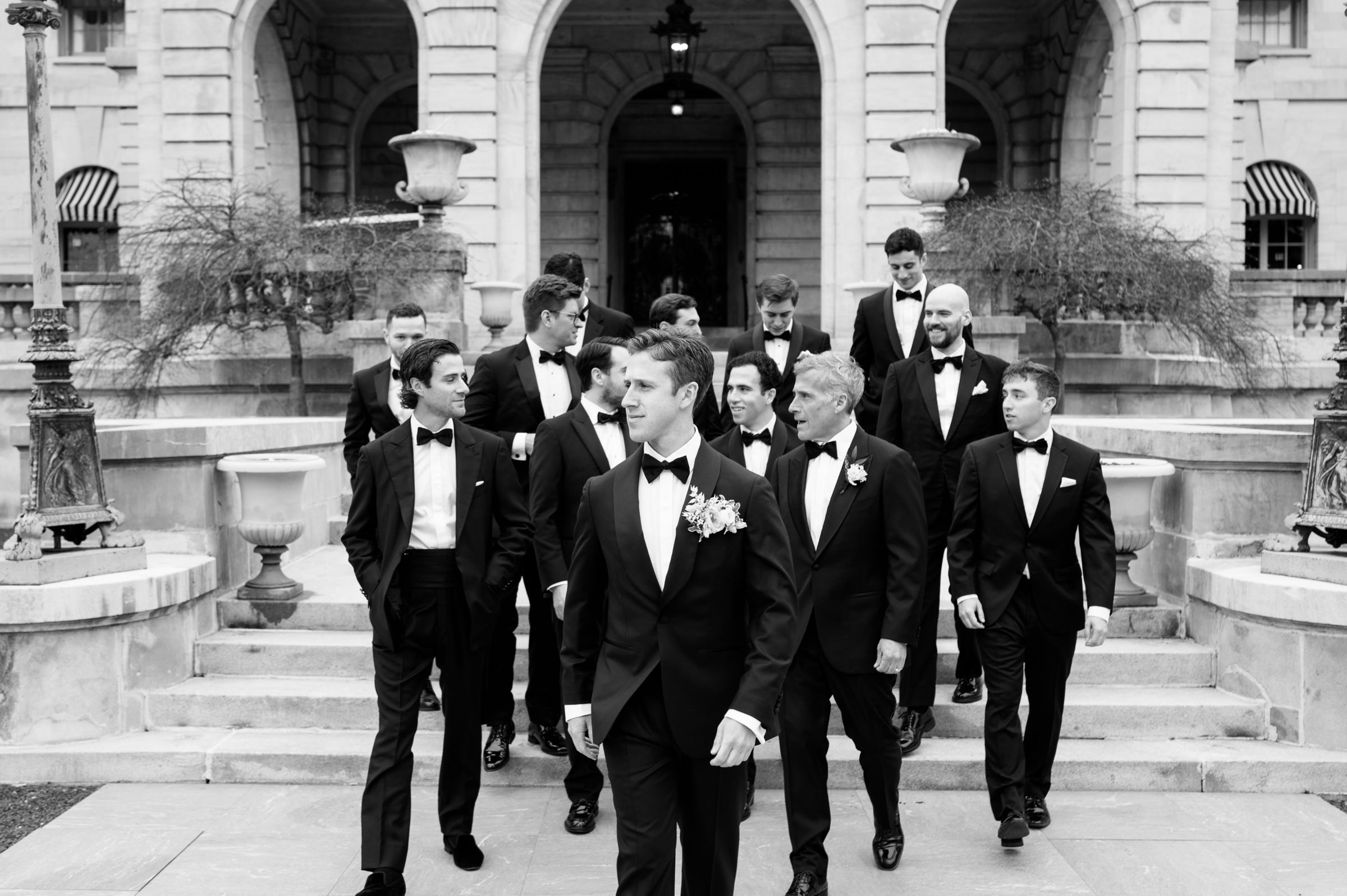 groom and groomsmen in classic suits and bow ties