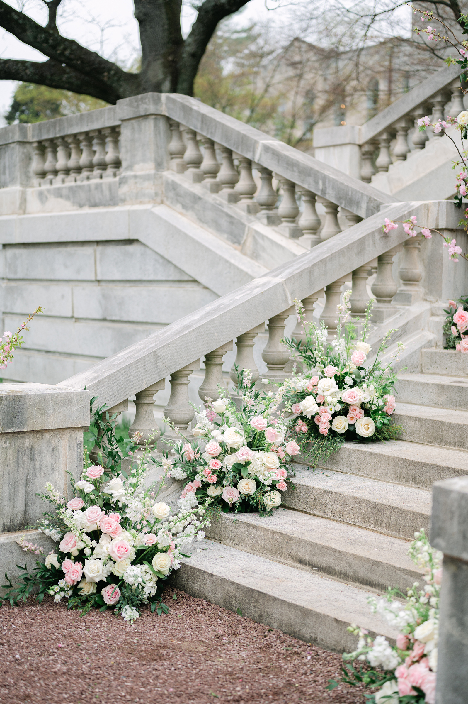 pink and white florals on staircase at wedding ceremony