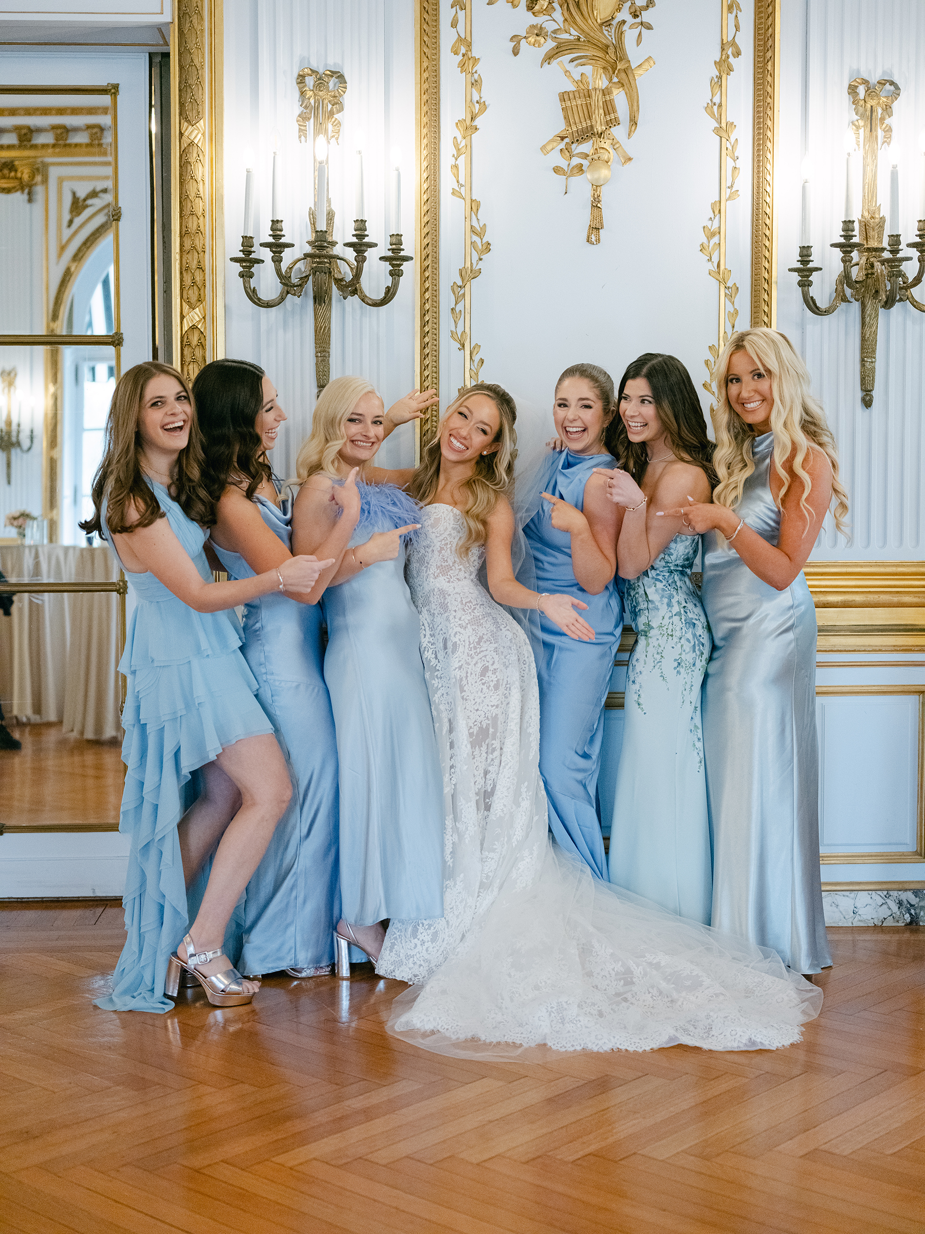 bride with bridesmaids wearing baby blue dresses