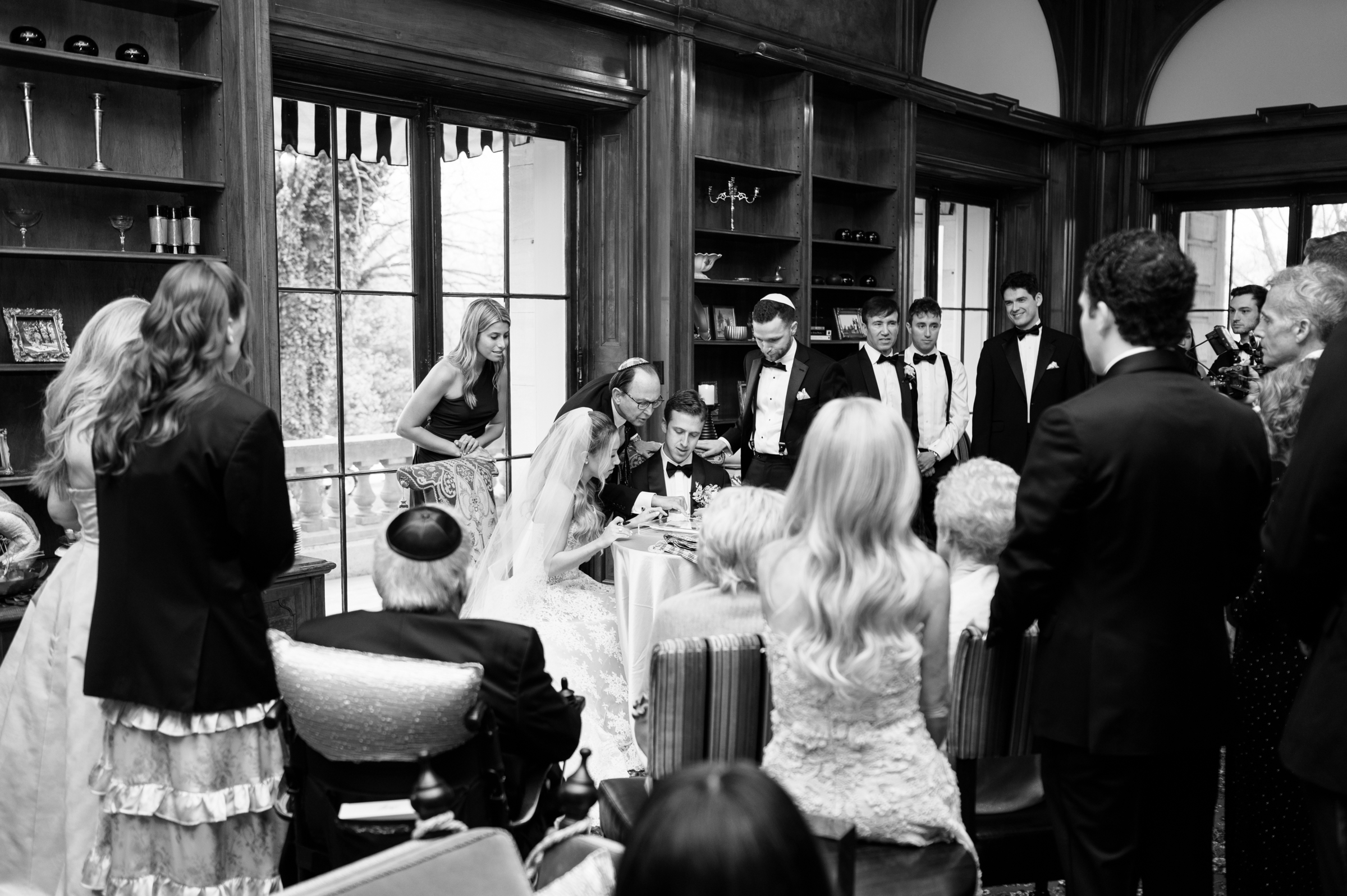bride and groom completing Ketubah