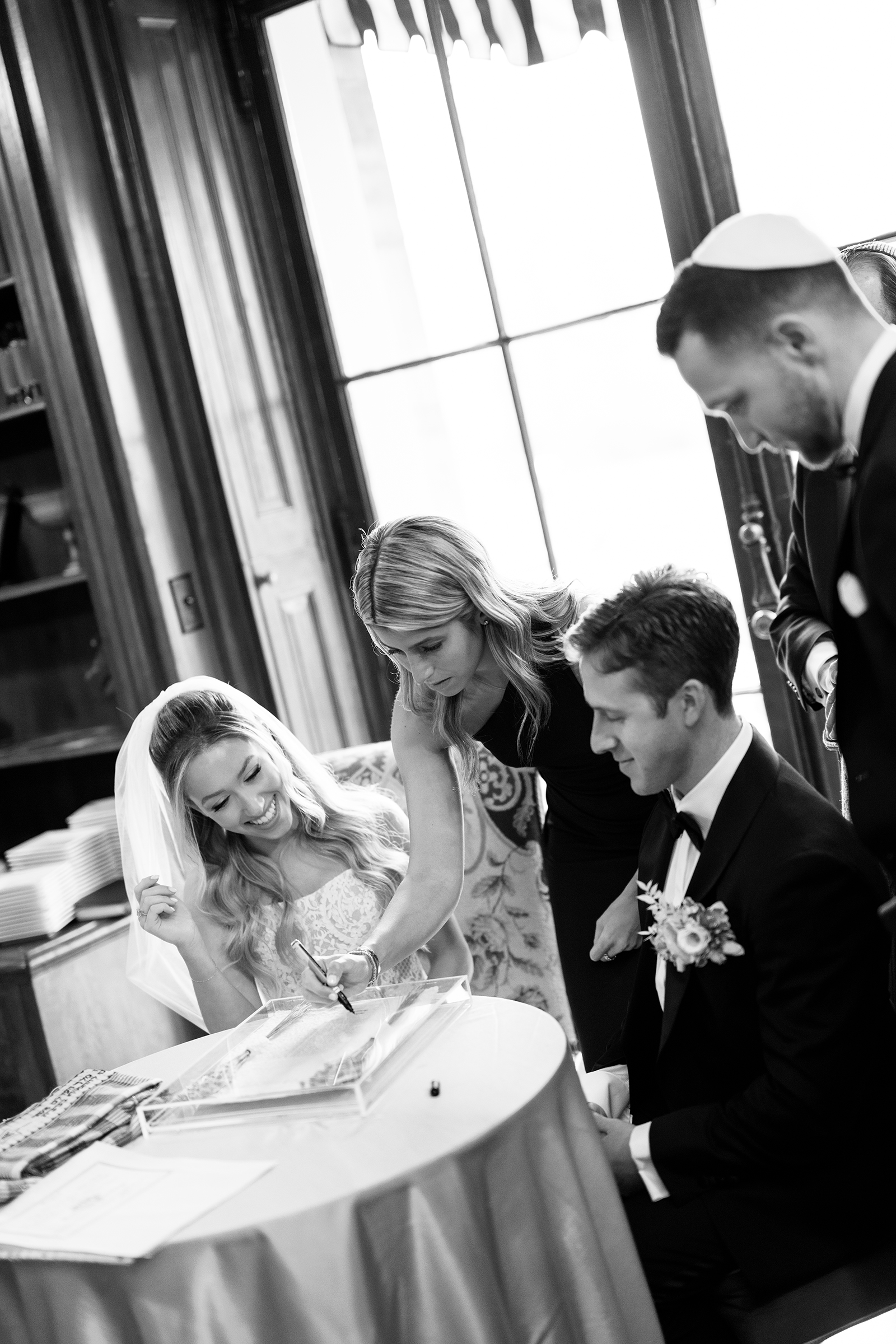 bride and groom completing Ketubah
