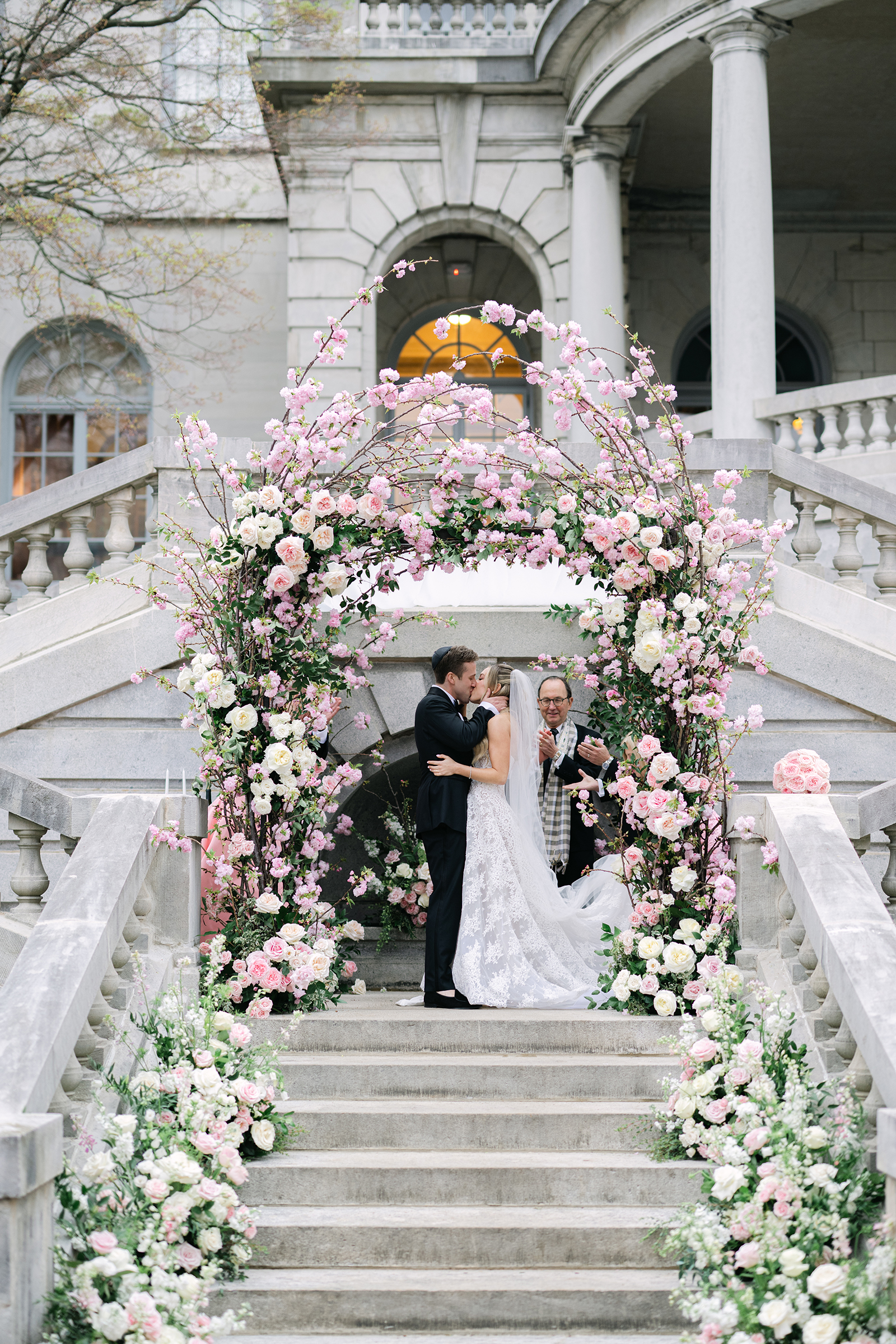 bride and groom kissing at wedding ceremony altar