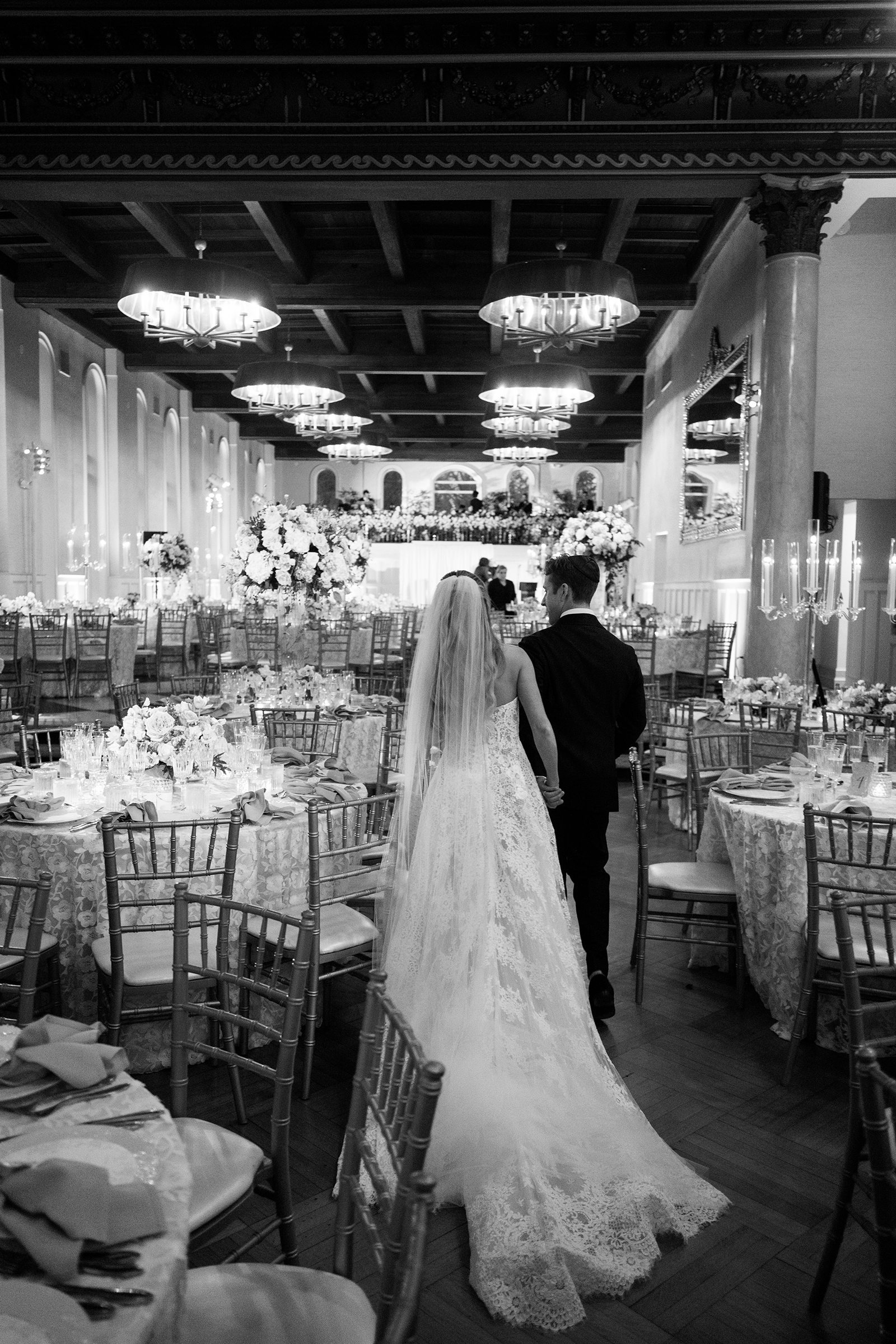 bride and groom entering the reception room