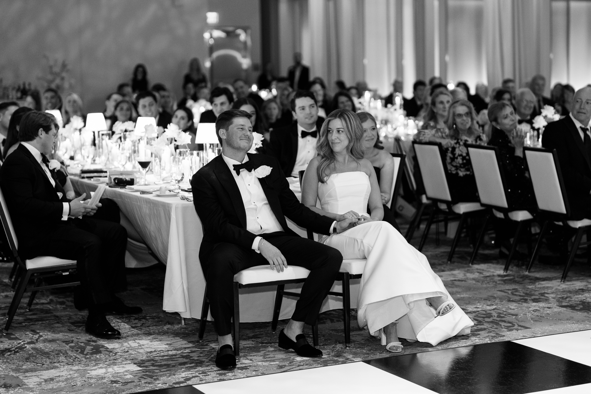 black and white picture of bride and groom at wedding reception
