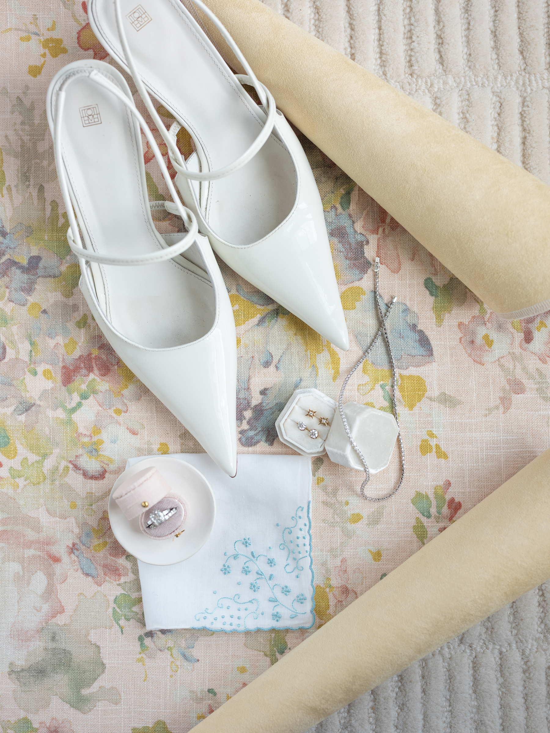 wedding flat lay of wedding shoes and ring