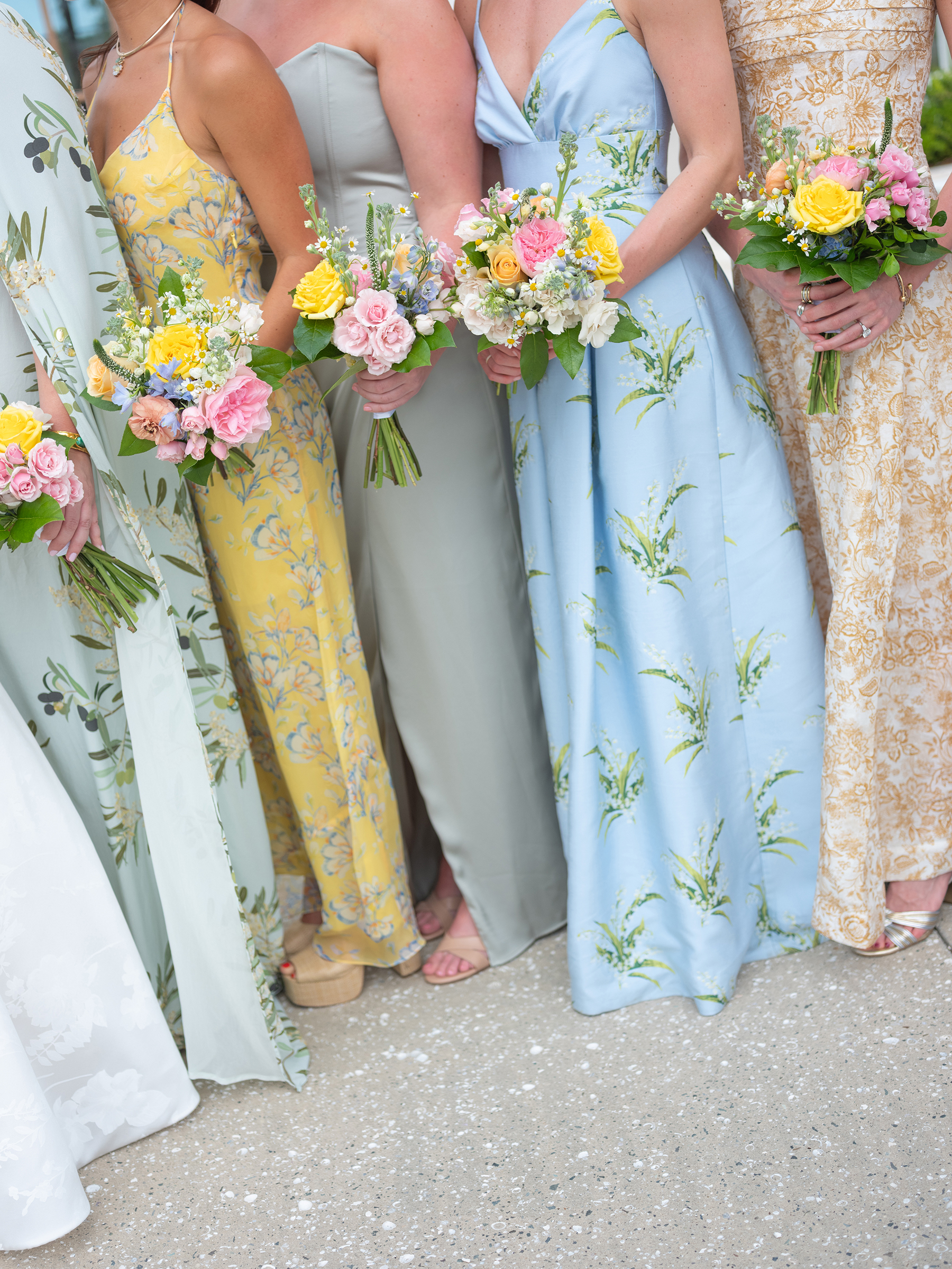 blue, green, yellow bridesmaids' dresses with colorful bouquets