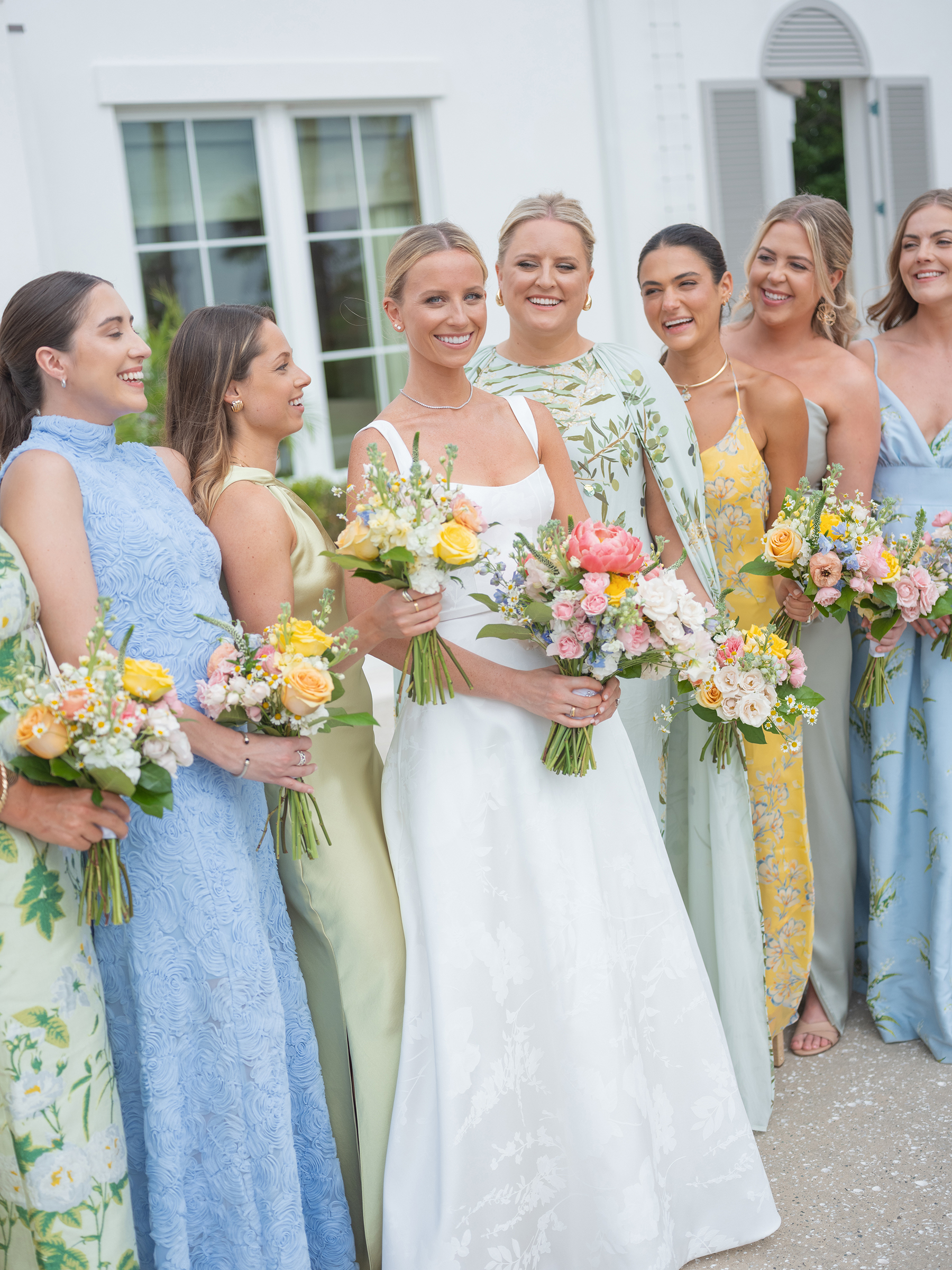 blue, green, yellow bridesmaids' dresses with colorful bouquets