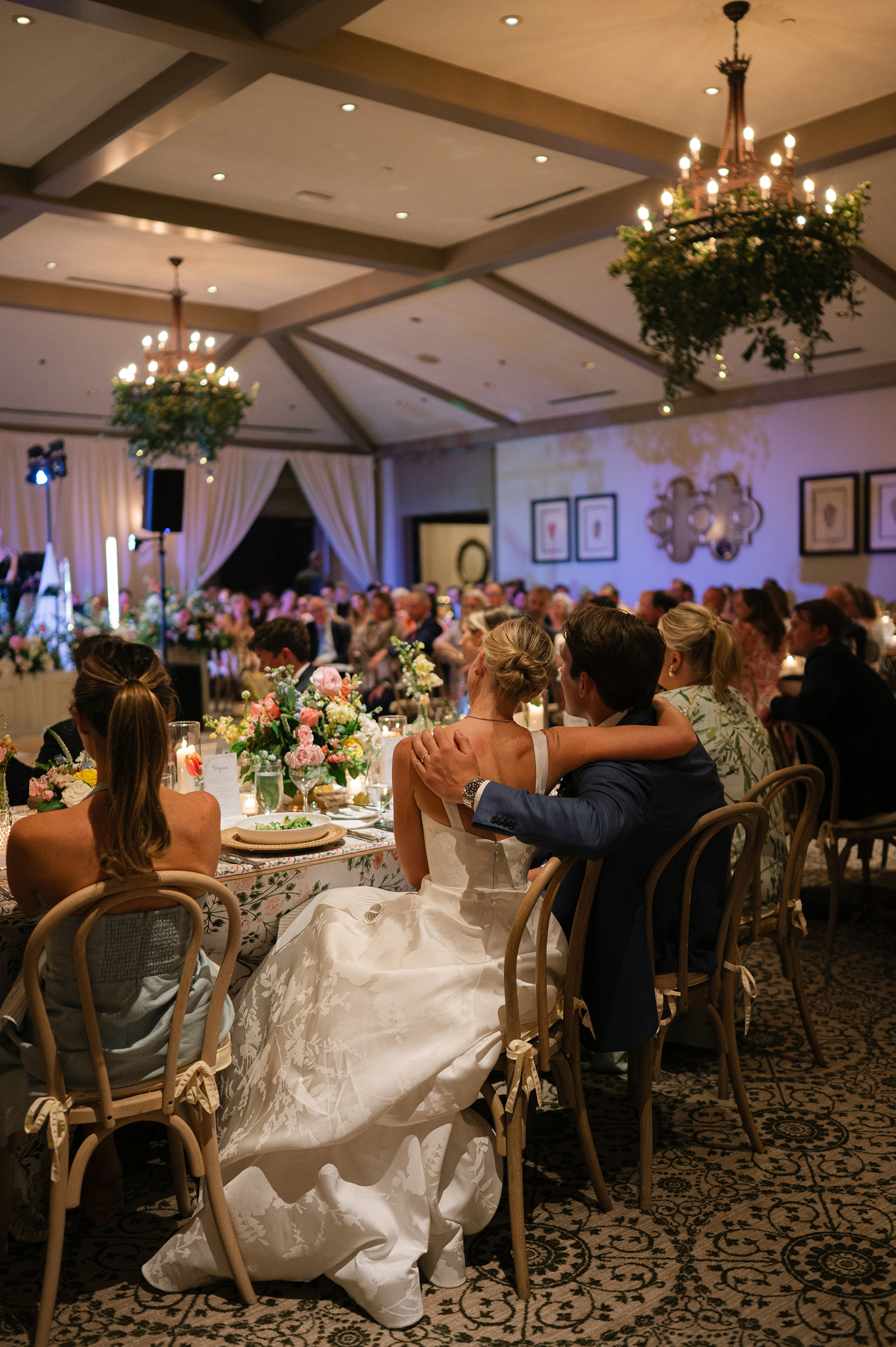 bride and groom listening to wedding speeches