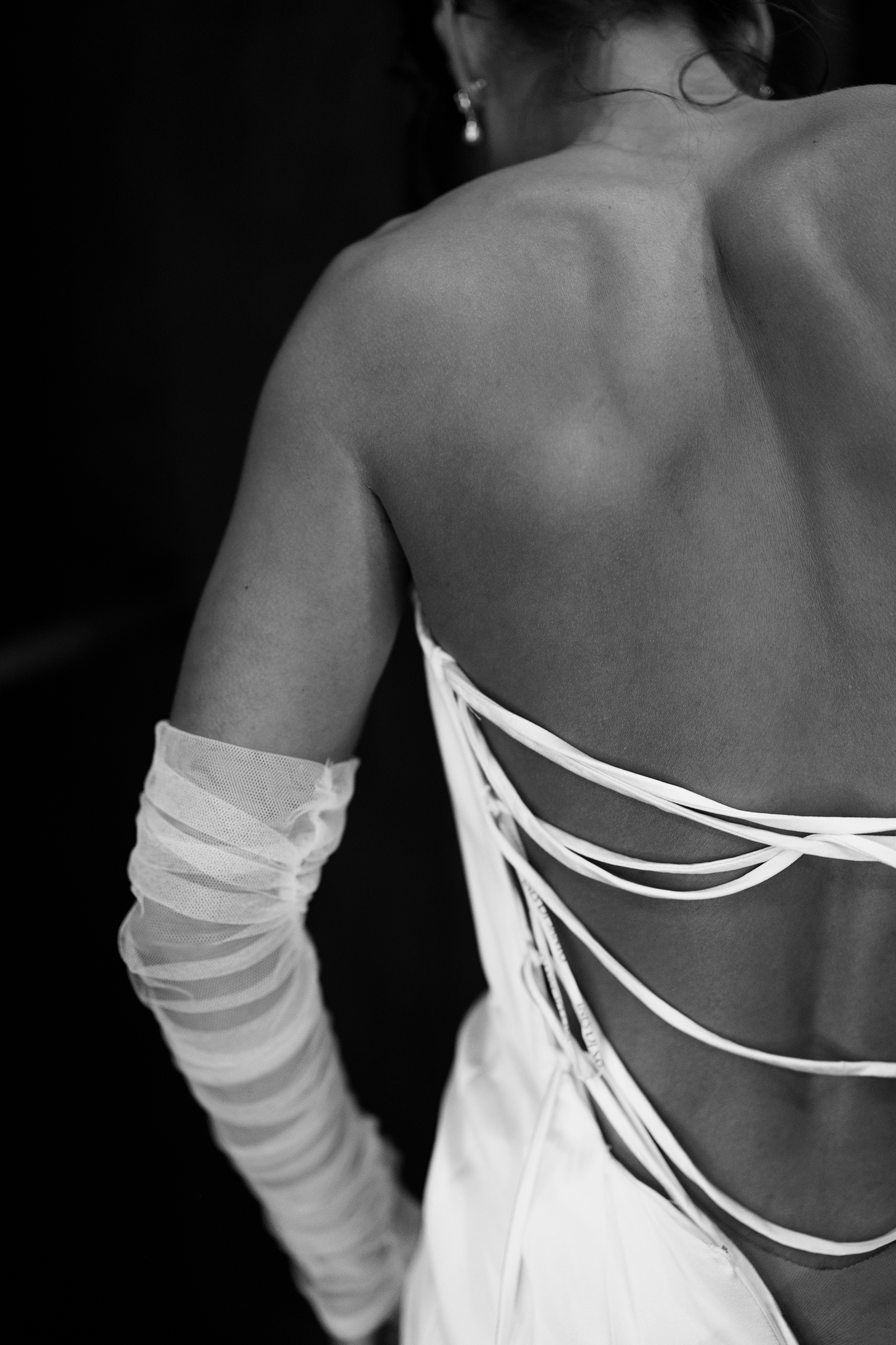 black and white picture of wedding dress details with open back