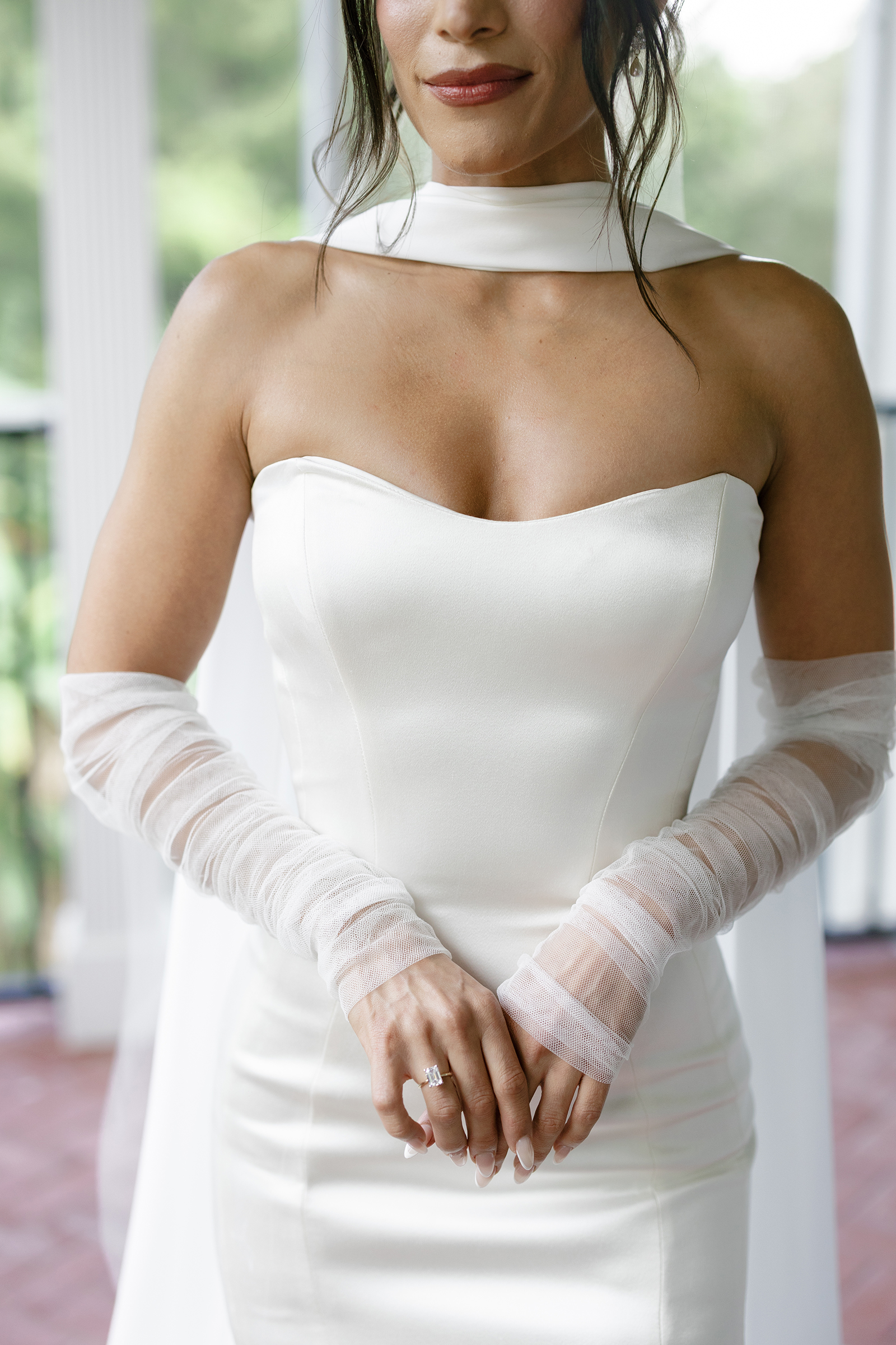 close-up picture of bride with a classic corset style wedding dress, neck scarf and sheer gloves
