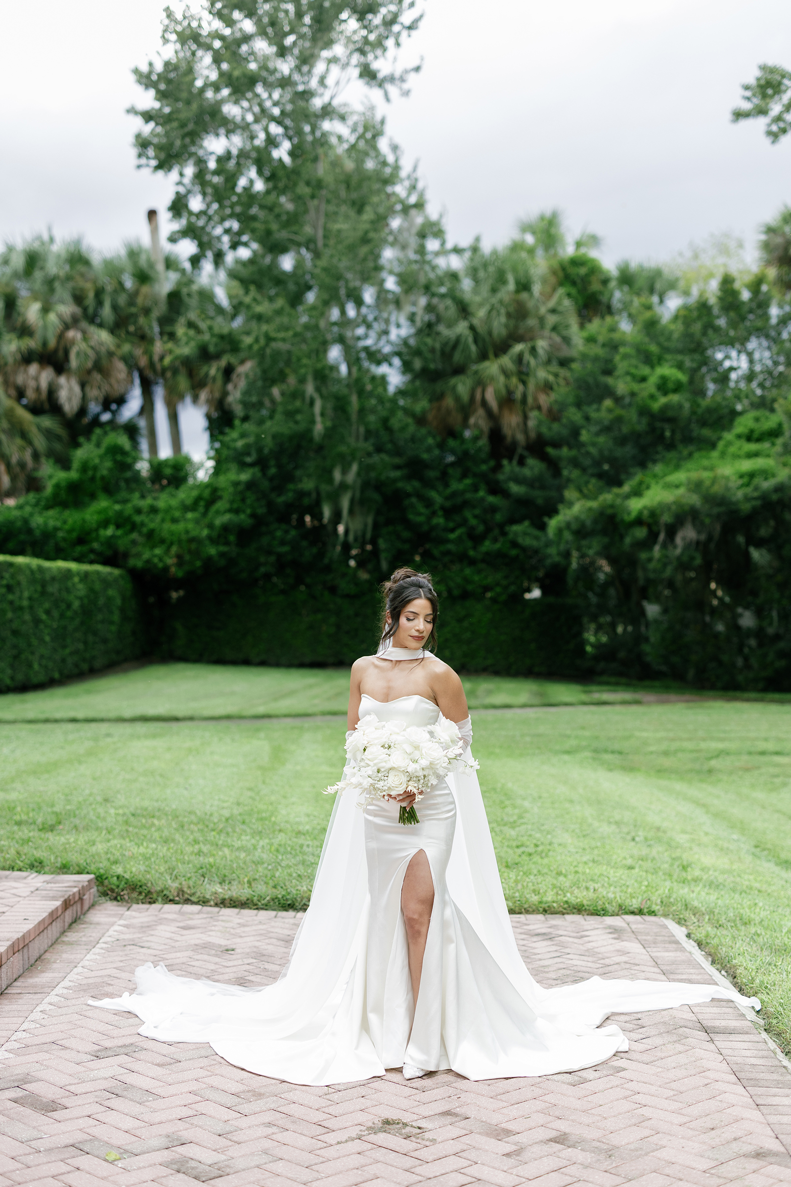 modern bride in corset style wedding dress with leg slit, neck scarf, sheer gloves