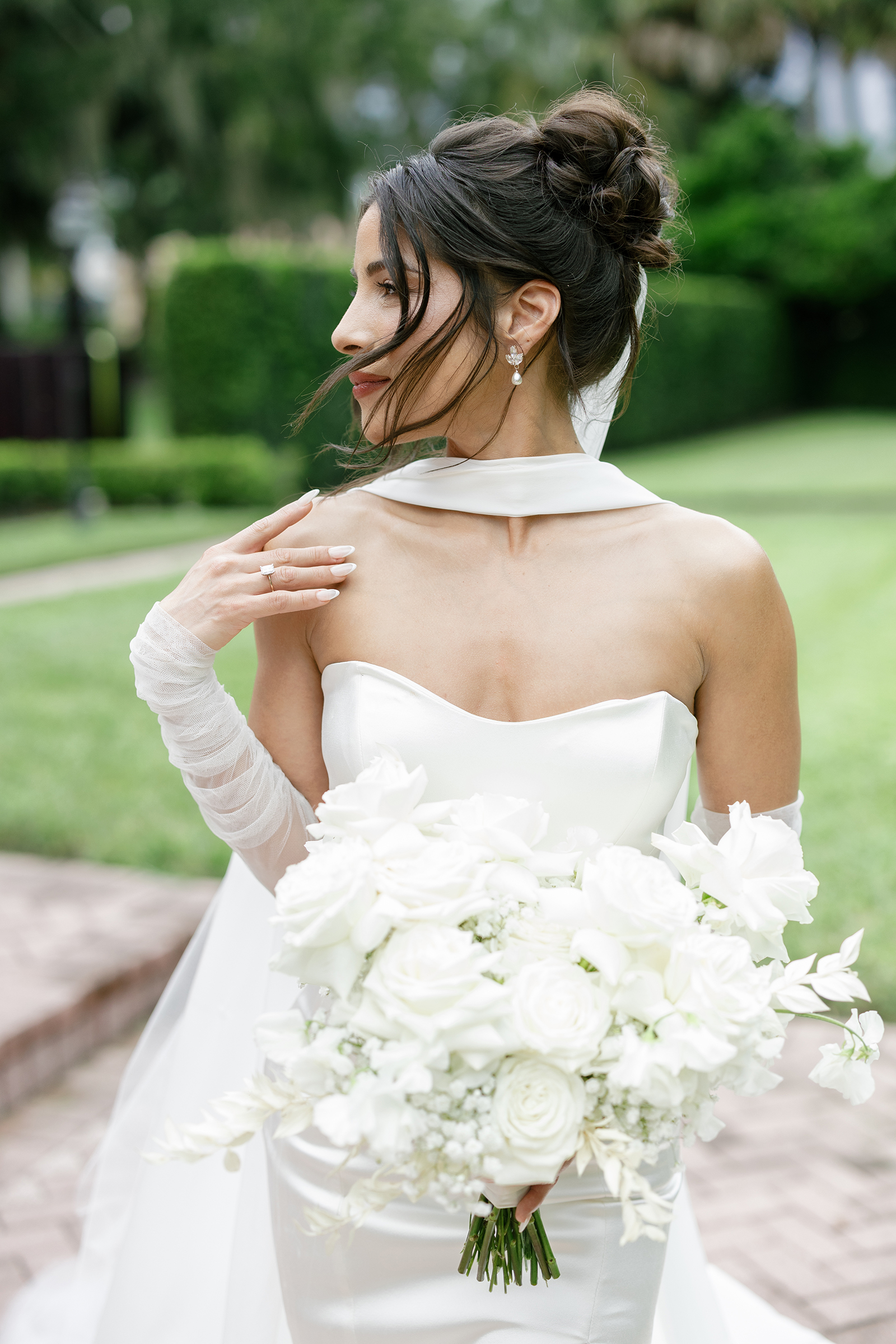 modern bride in corset style wedding dress with leg slit, neck scarf, sheer gloves