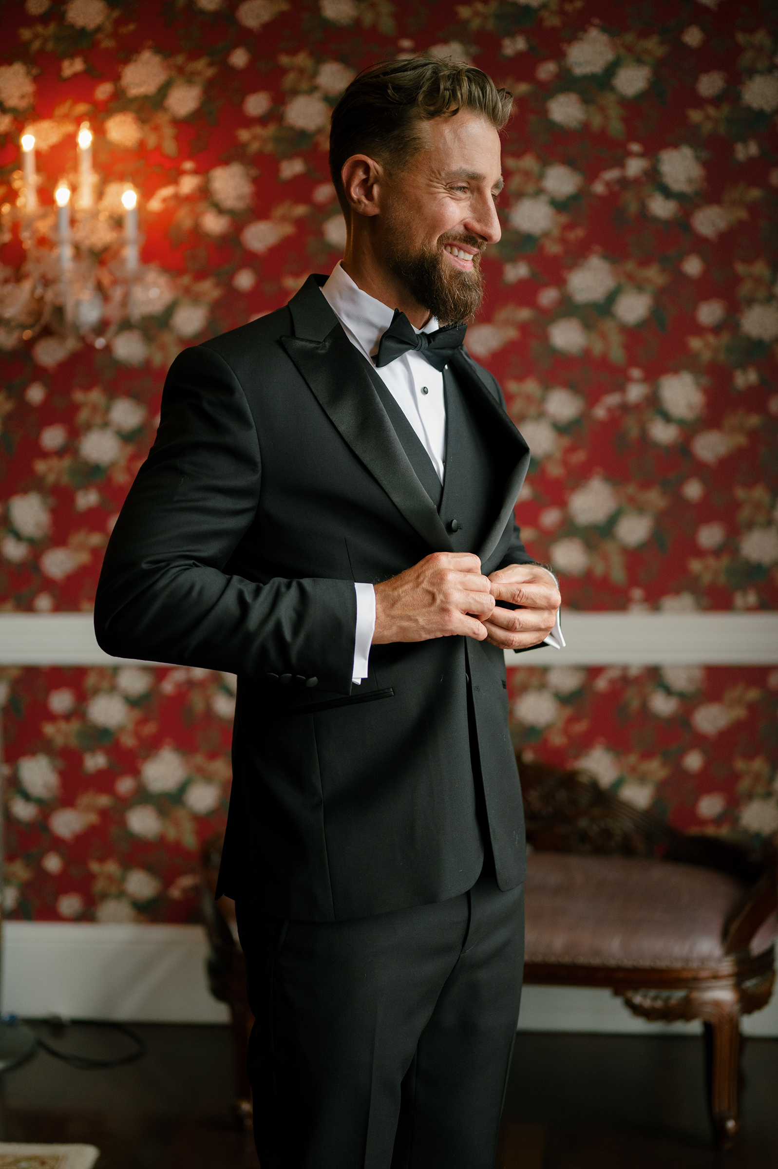 groom getting ready with black tux and bow tie