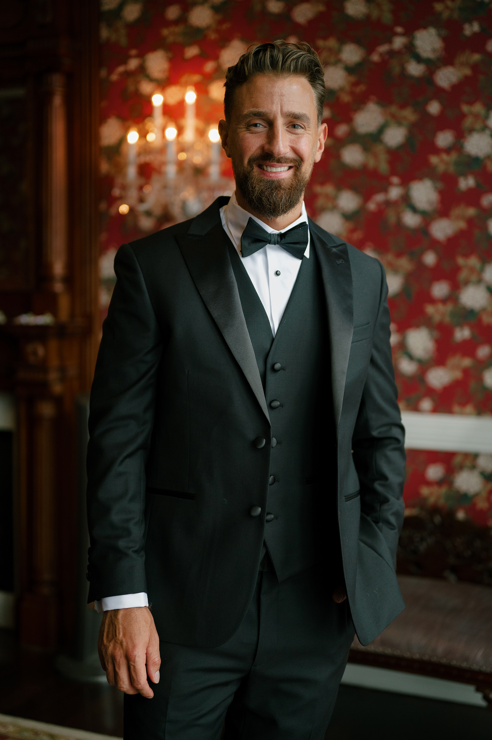 groom getting ready with black tux and bow tie