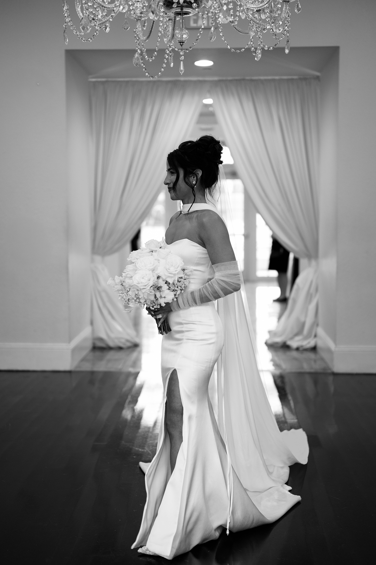 black and white picture of bride walking down the aisle