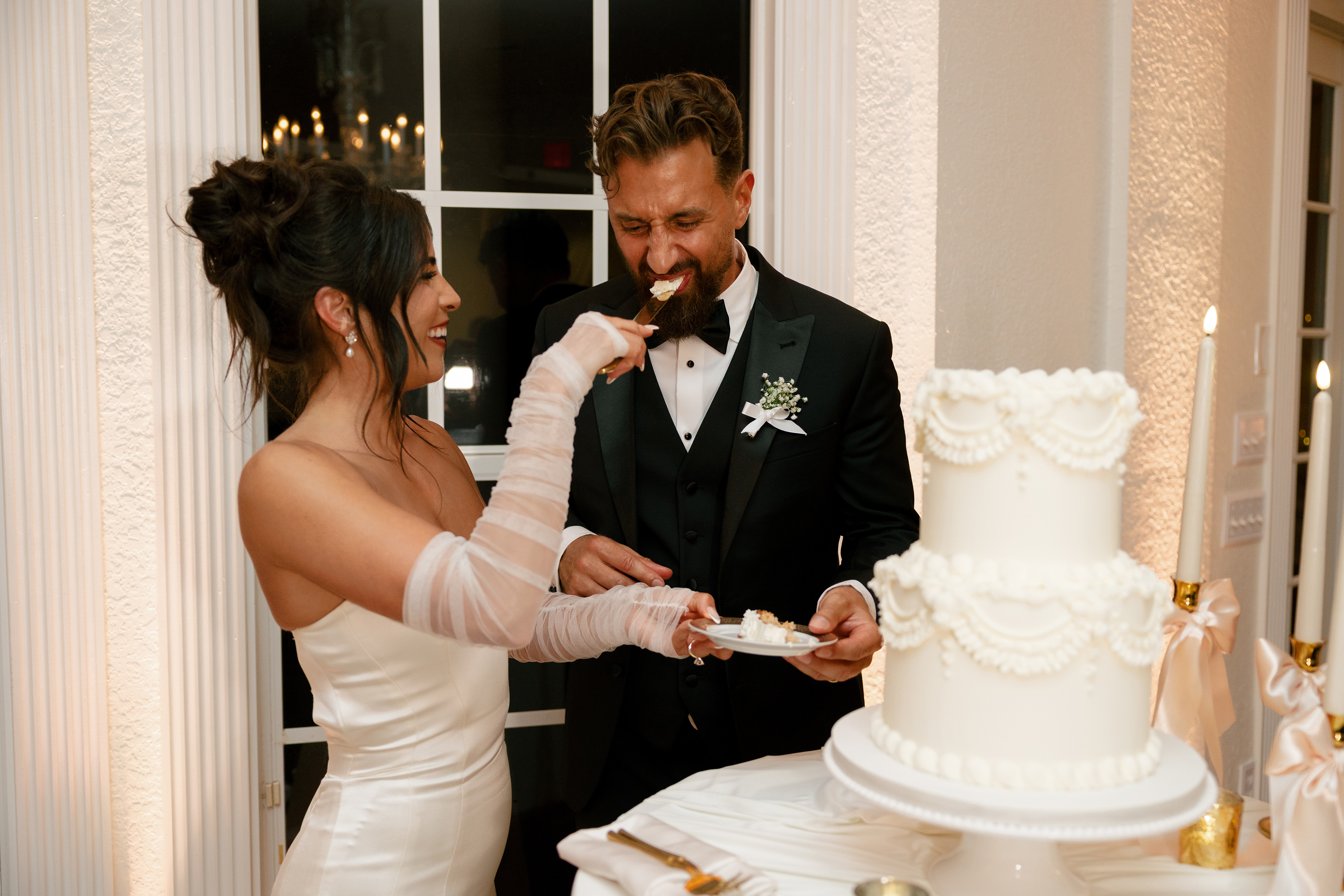 bride and groom cutting wedding cake