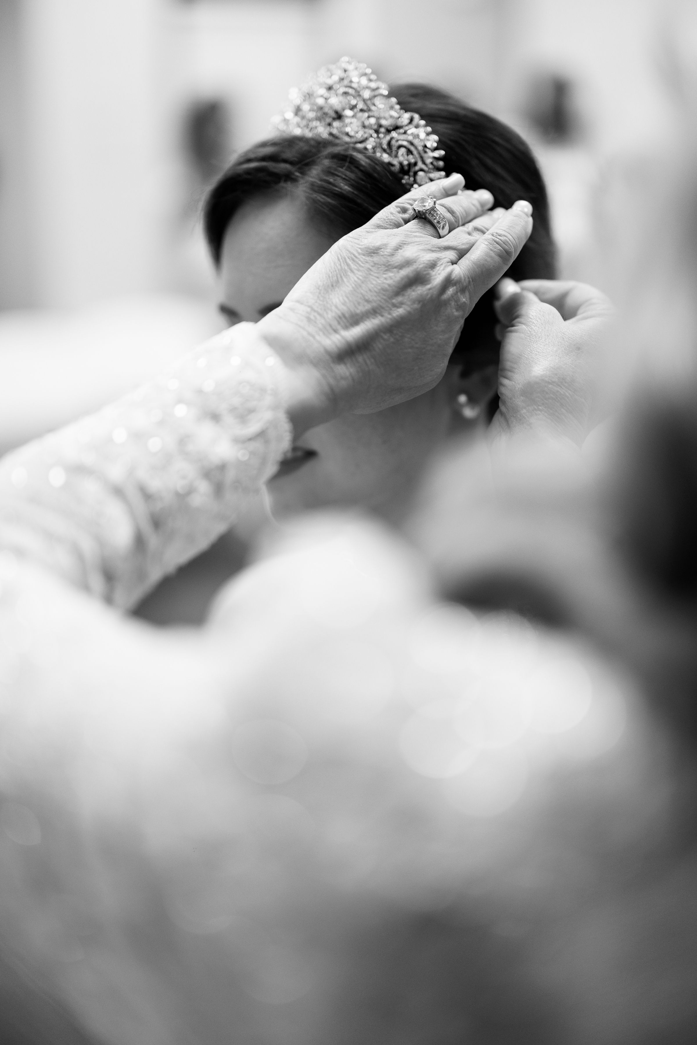 black and white wedding portrait of bride getting ready