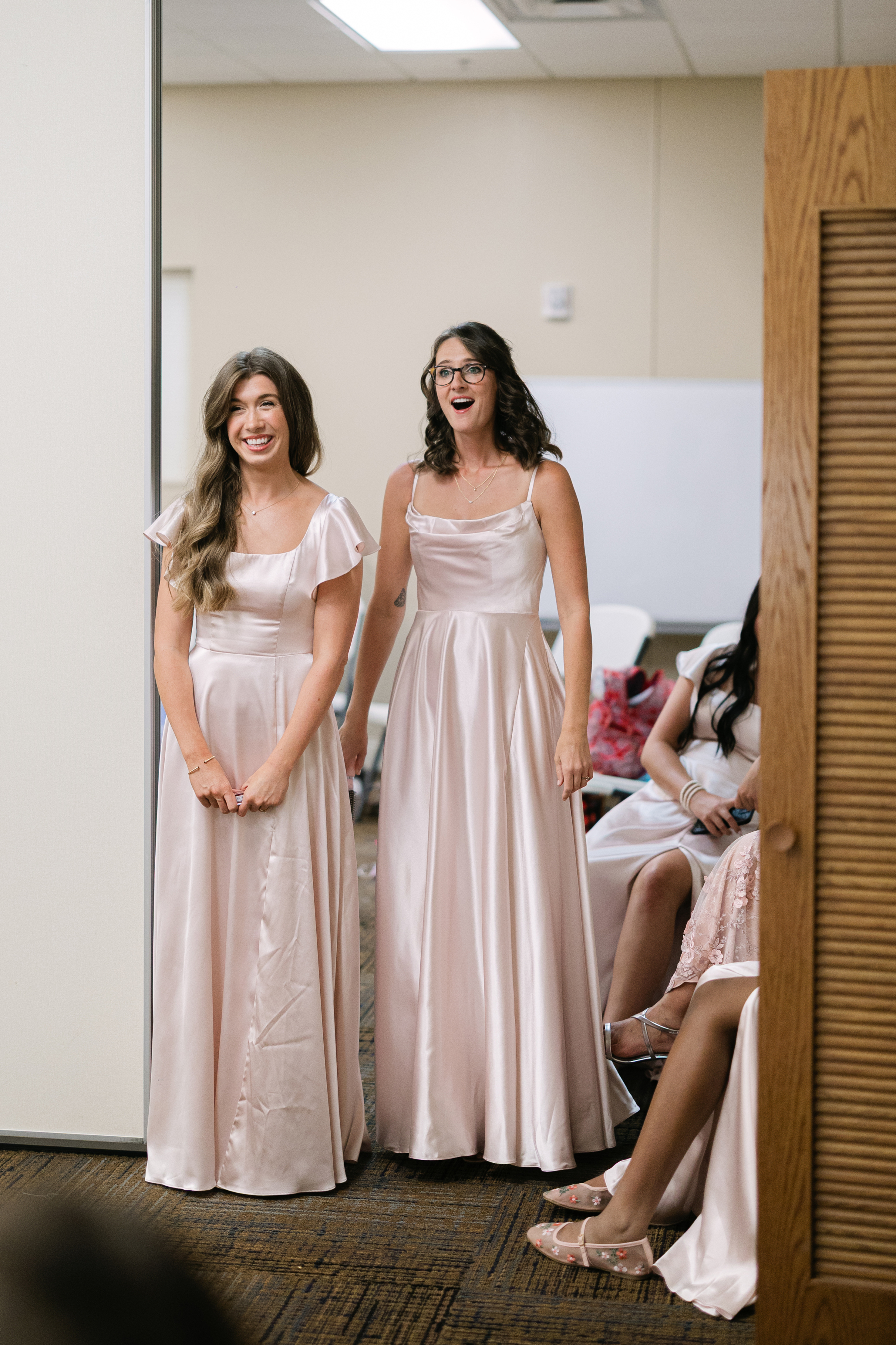 bridesmaids wearing blush pink colors during first look