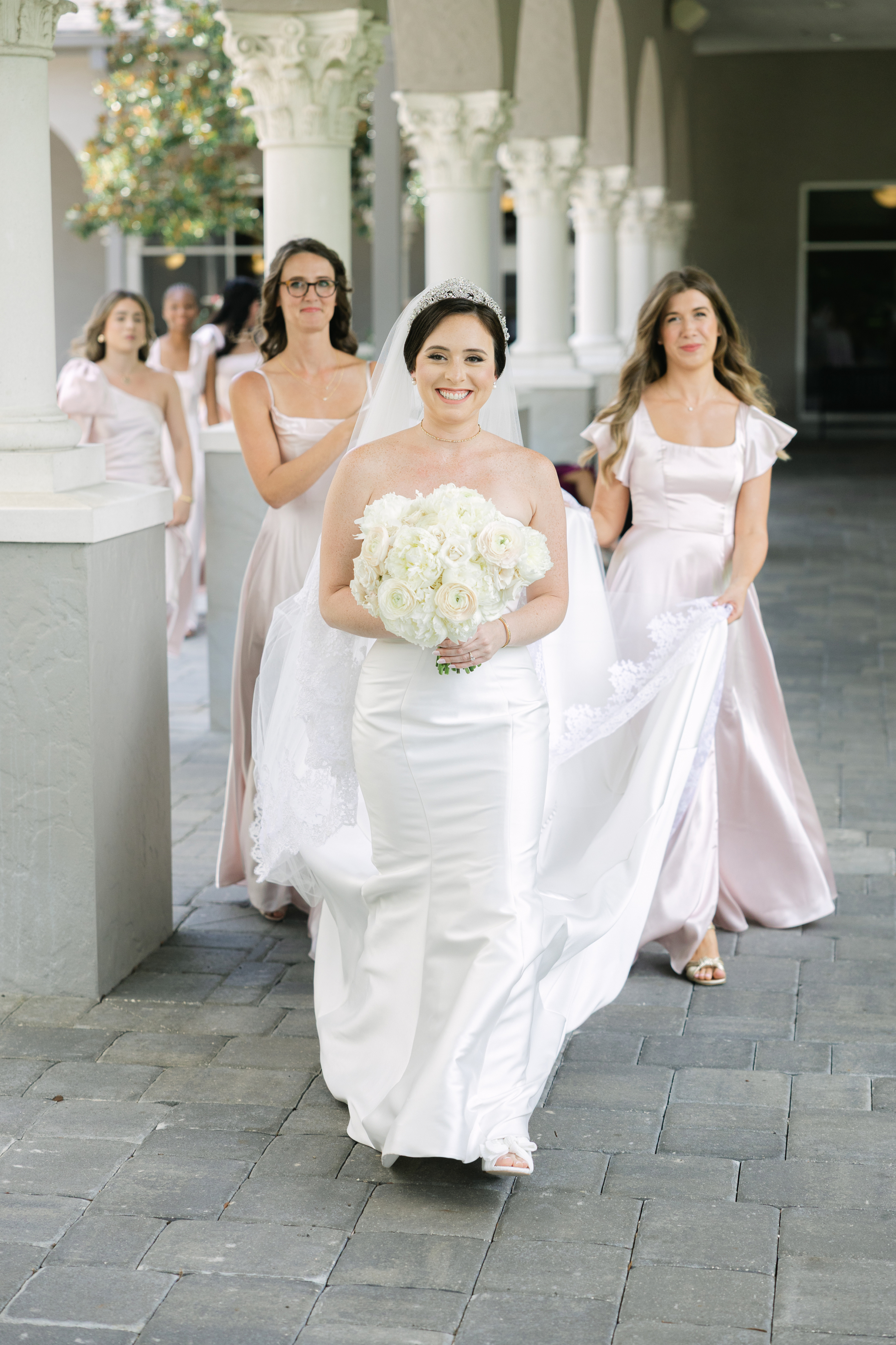 clean and minimalist wedding dress with pink blush bridesmaids