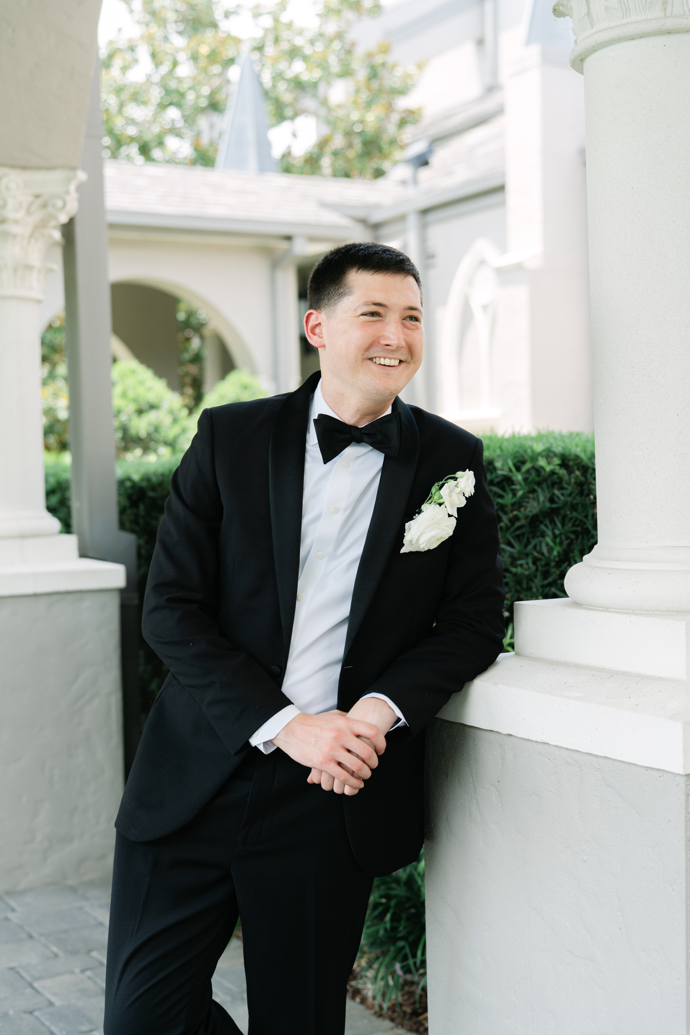 wedding portrait of groom wearing black tux and black bow tie