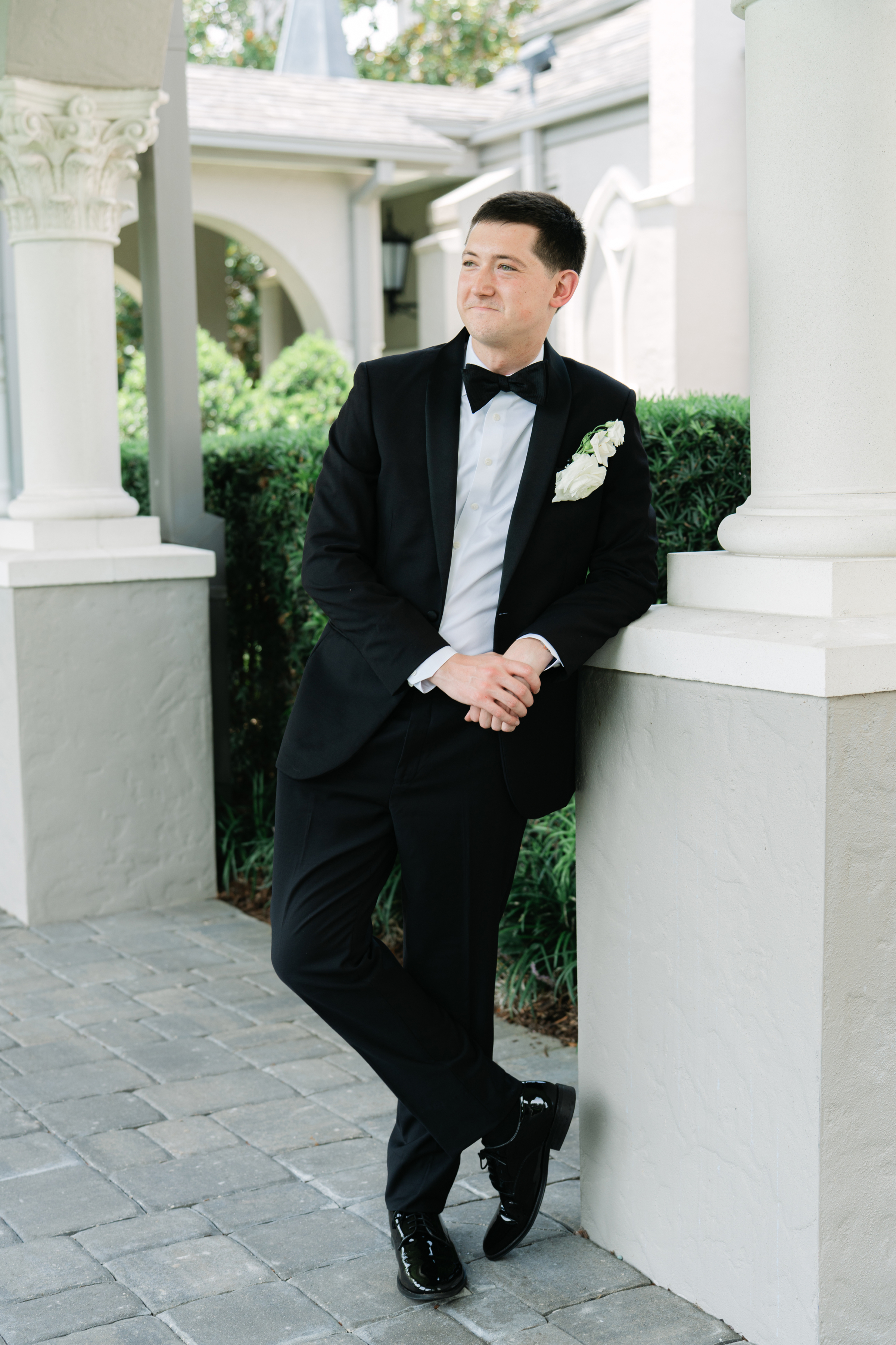 wedding portrait of groom wearing black tux and black bow tie