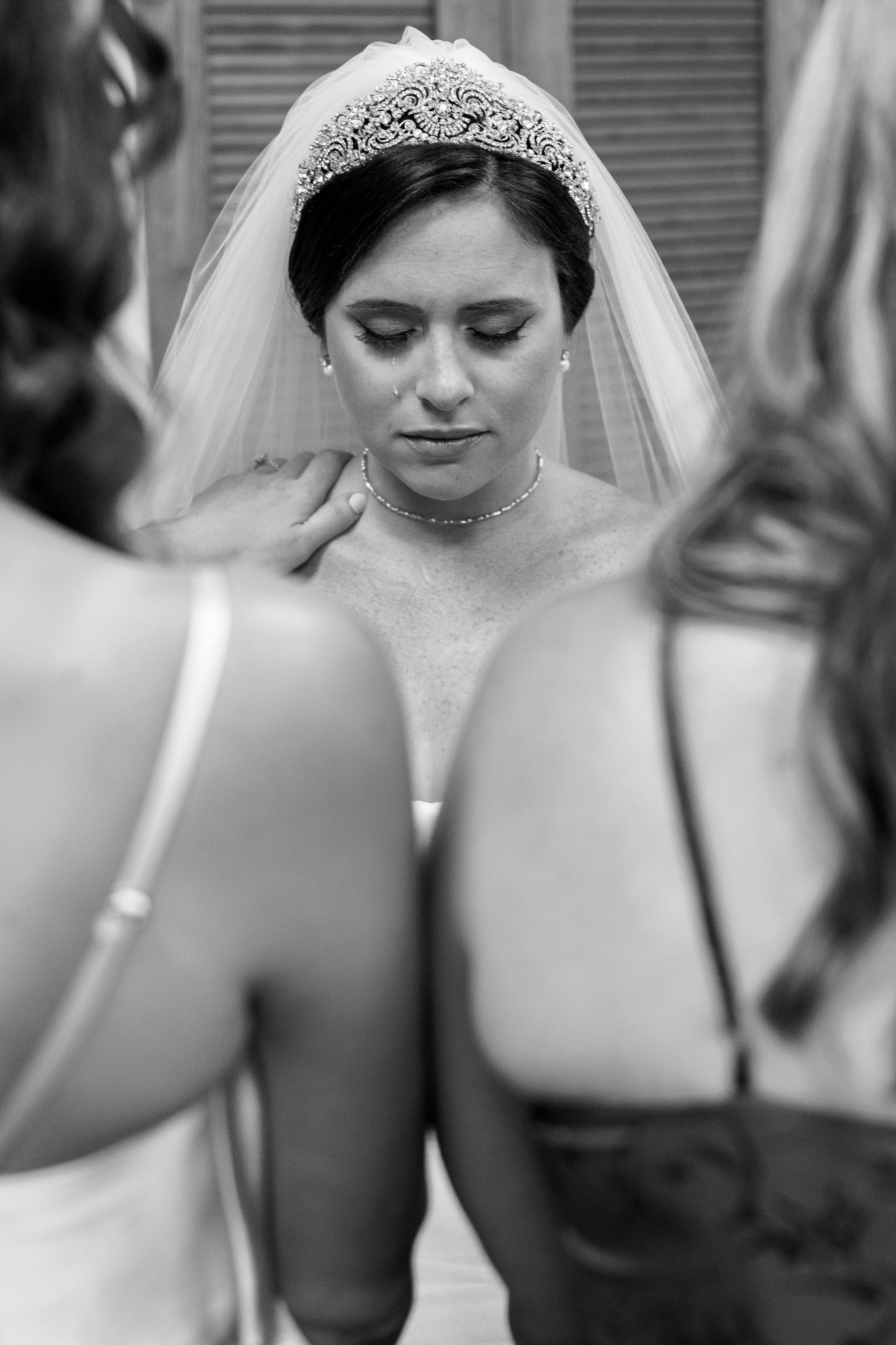 black and white wedding portrait of bride during prayers