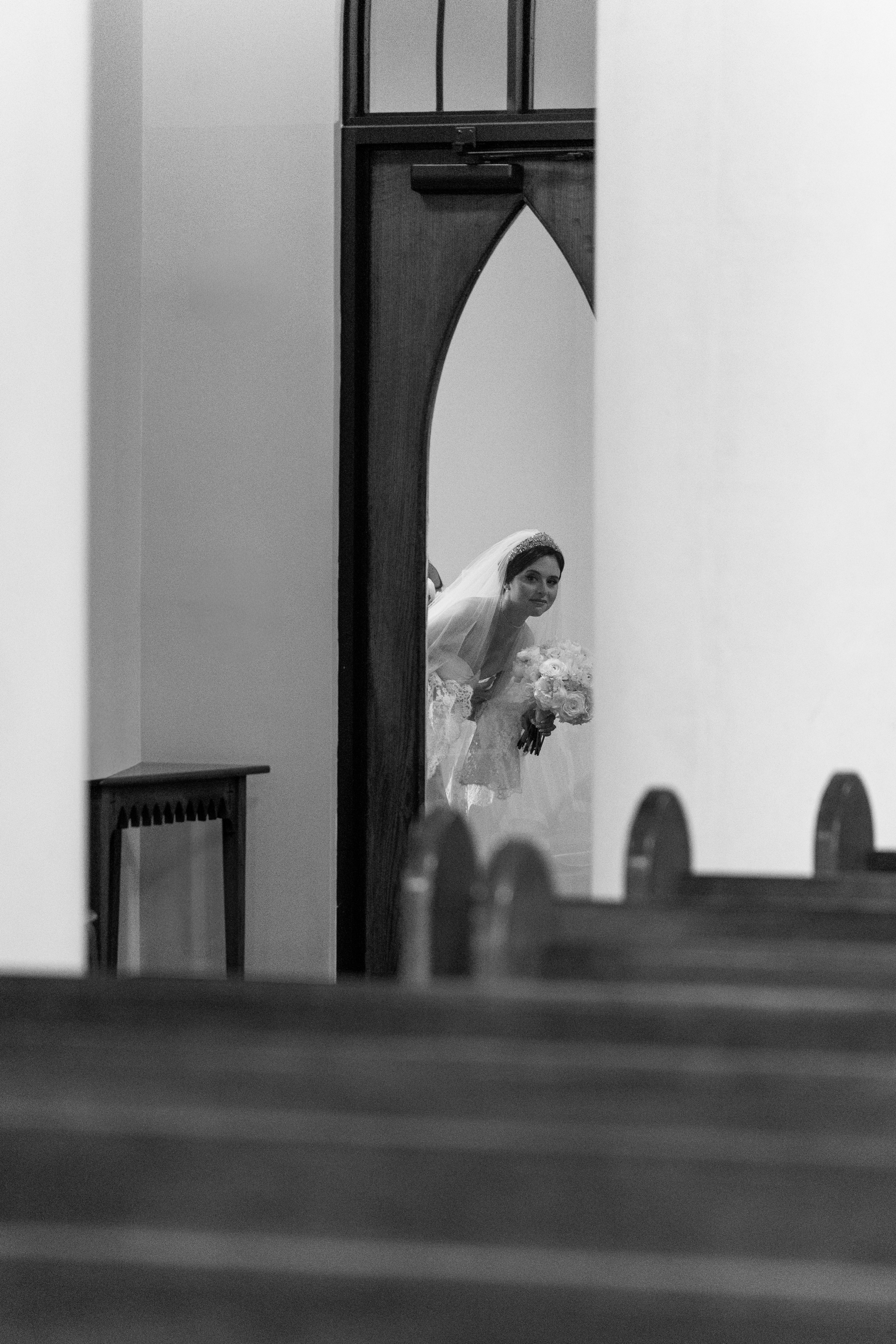 black and white picture of bride during wedding ceremony