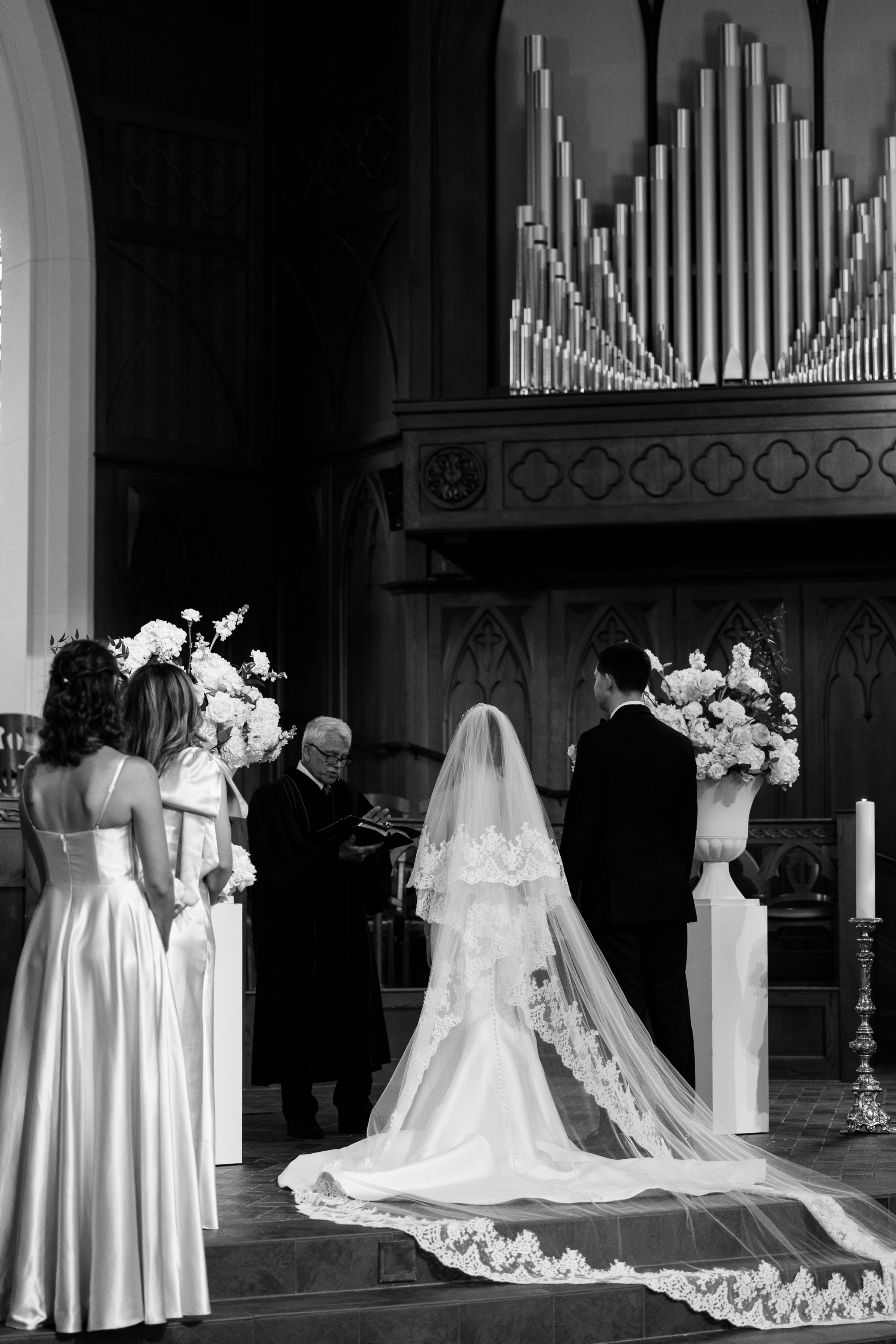 black and white picture of bride and groom at chapel wedding