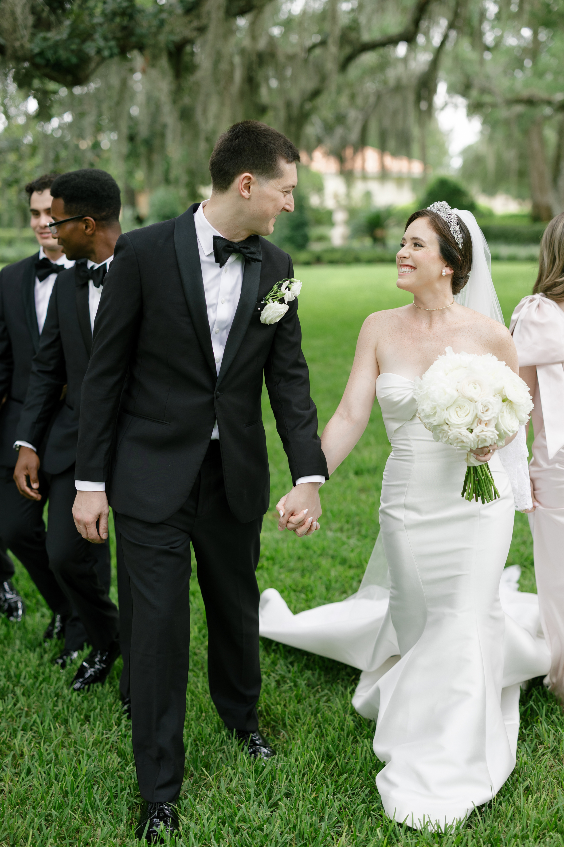 bride and groom walking with wedding party