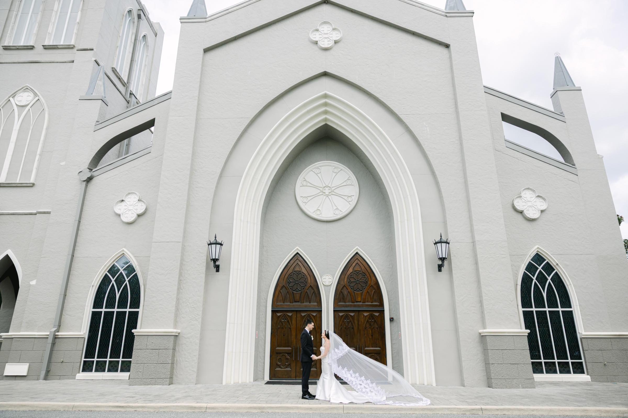 classy and traditional bride and groom portraits in front of chapel
