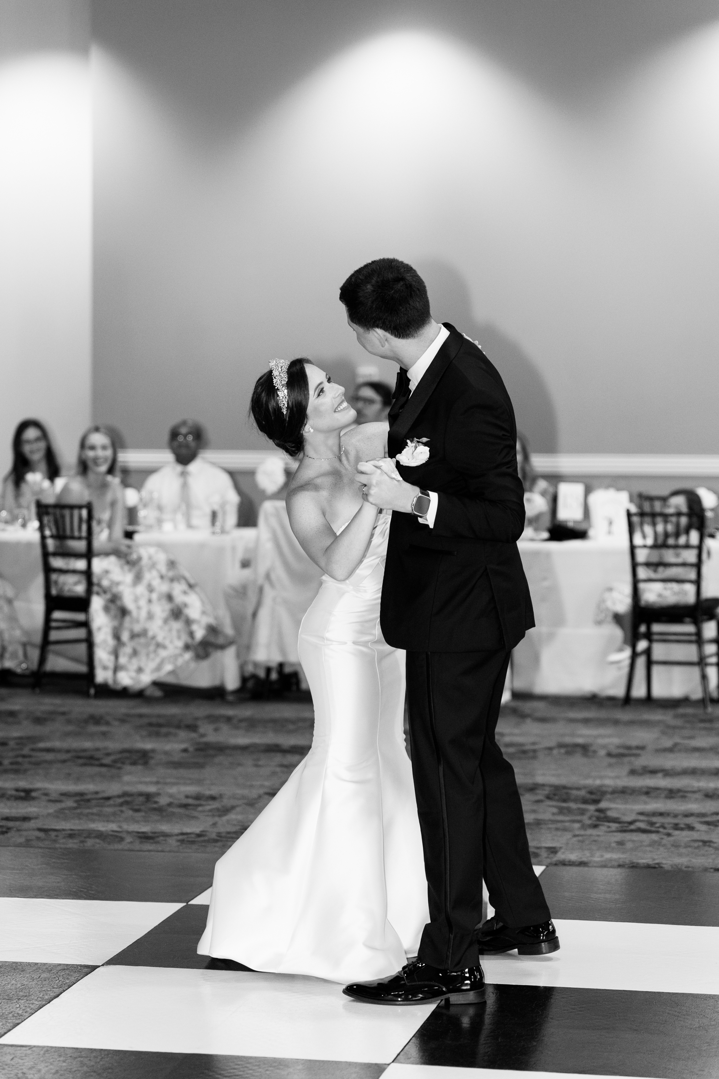 black and white picture of bride and groom having first dance at wedding reception