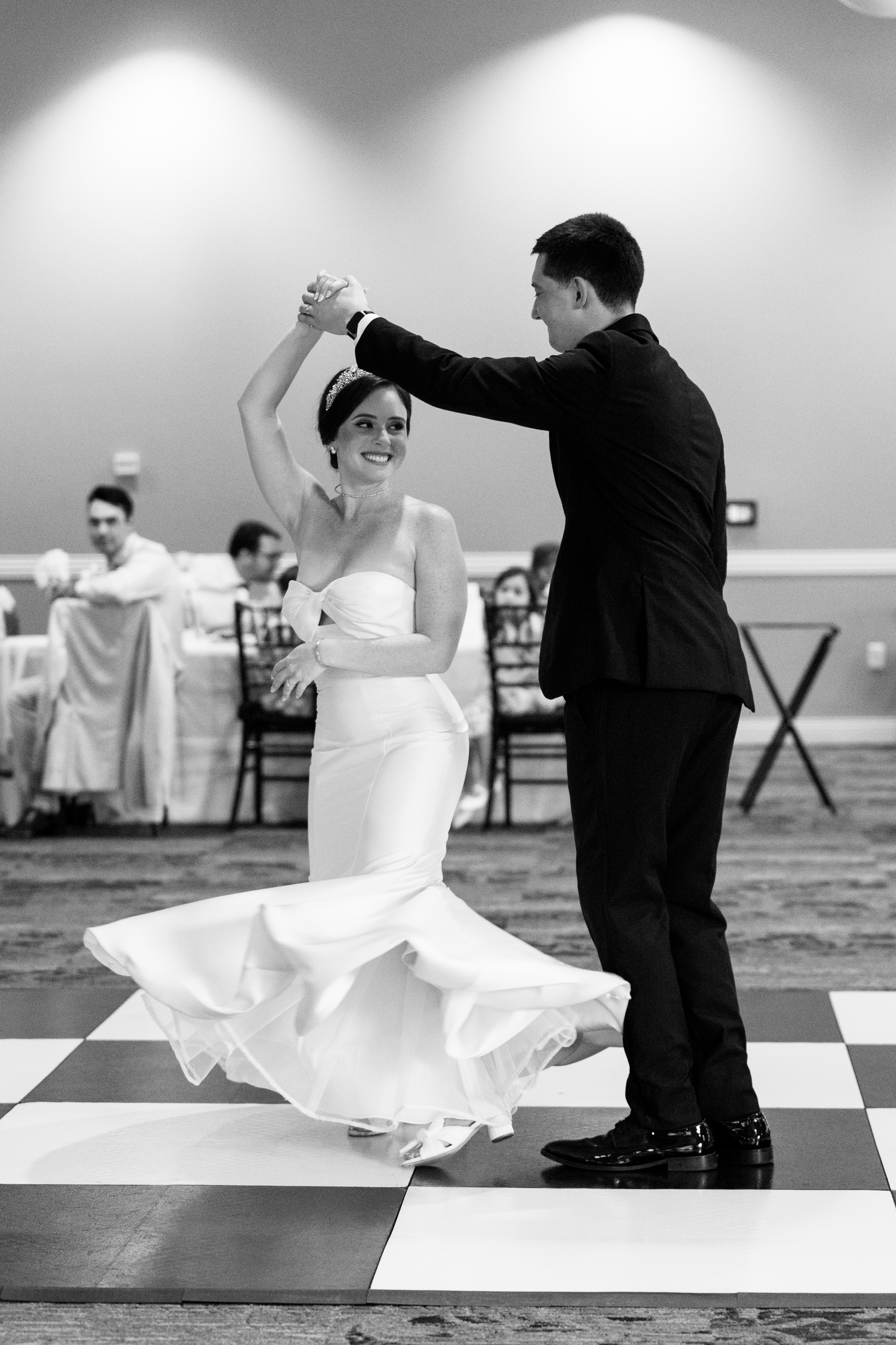 black and white picture of bride and groom having first dance at wedding reception